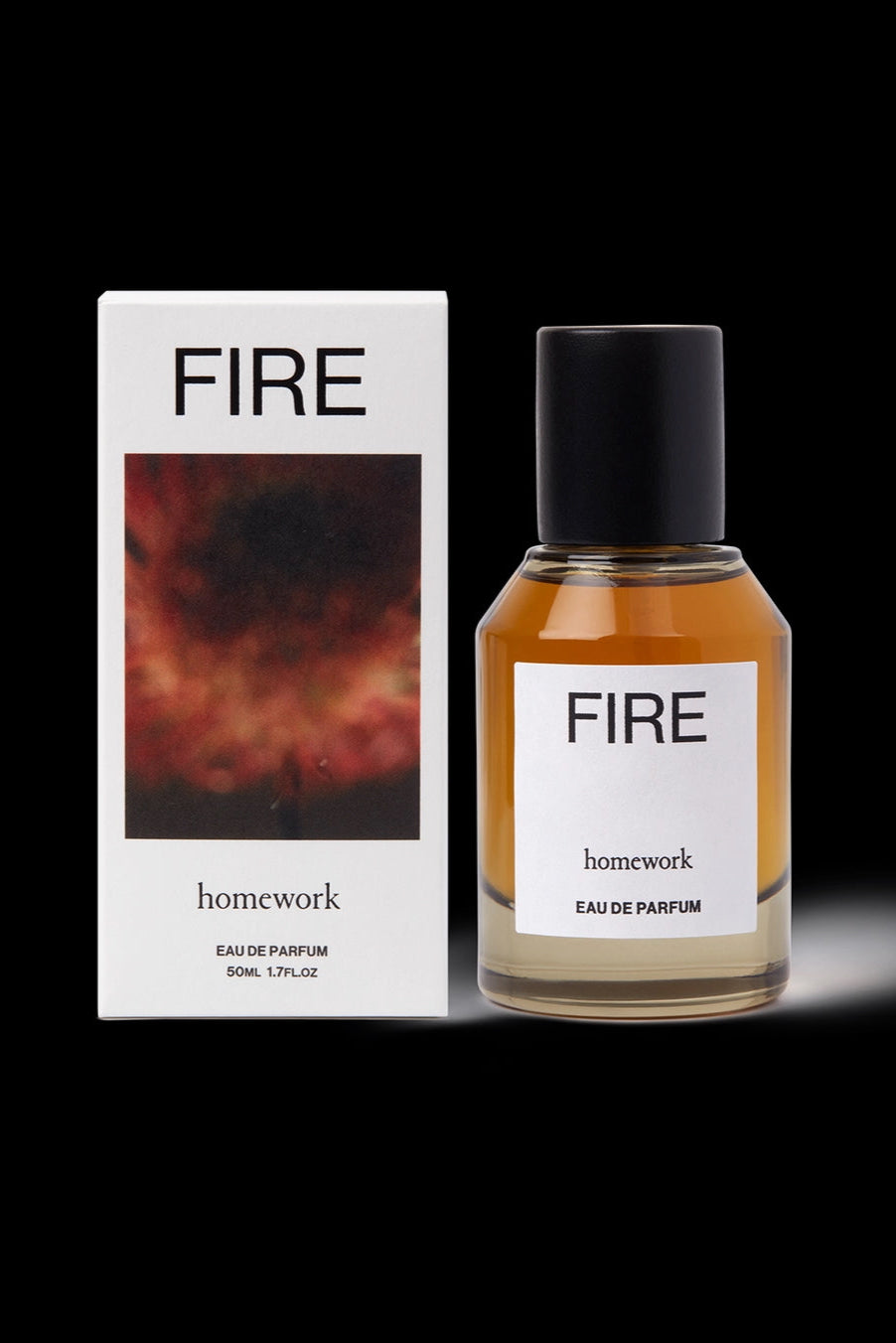 Fire Eau de Parfum Perfume bottle and packaging labeled 'FIRE' by 'homework' on a black background ©Homework