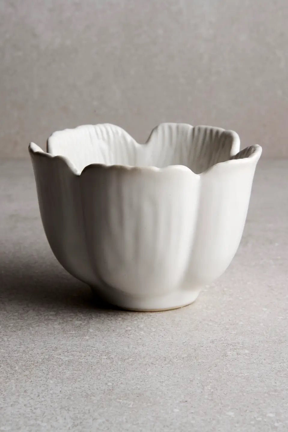 Large Petal Bowl shown from the side looking slightly in against a grey wall ©Goodies