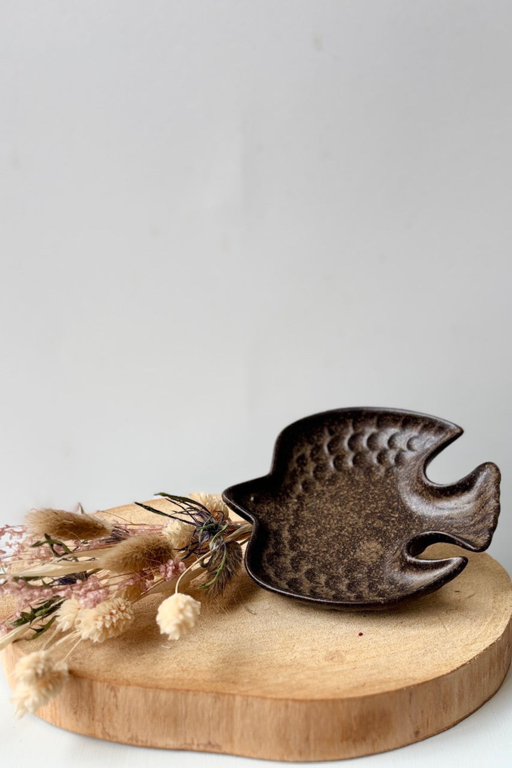 Ceramic bird-shaped dish with a wooden surface on a white background ©Sprout Home
