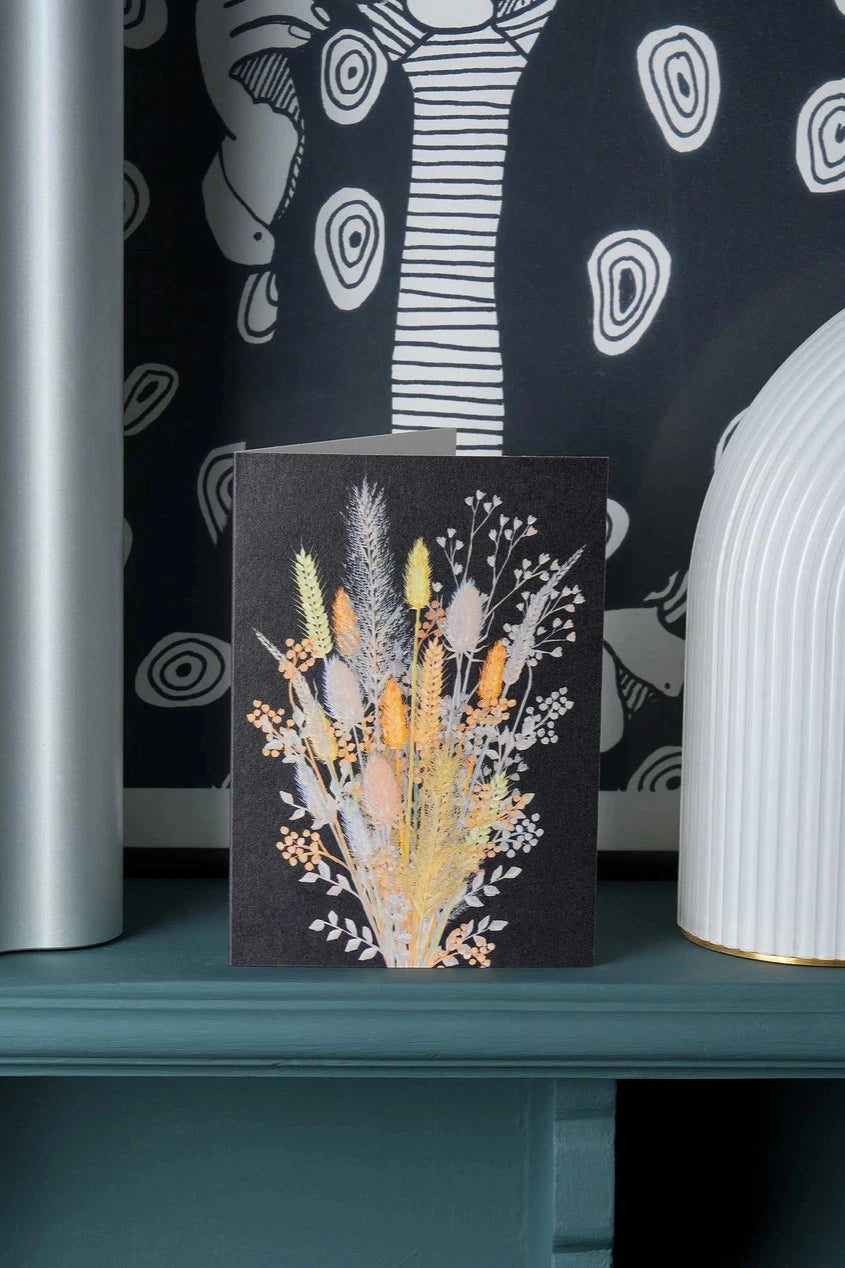 Dried Stems card by Stengun Drawings on a shelf of black and white so the warm colors of the stems in the card stand out.