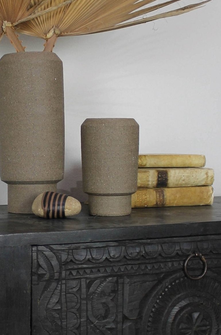 Small Valdez vase natural clay by Homeart shown  on a credenza with a larger Valdez vase to the side.