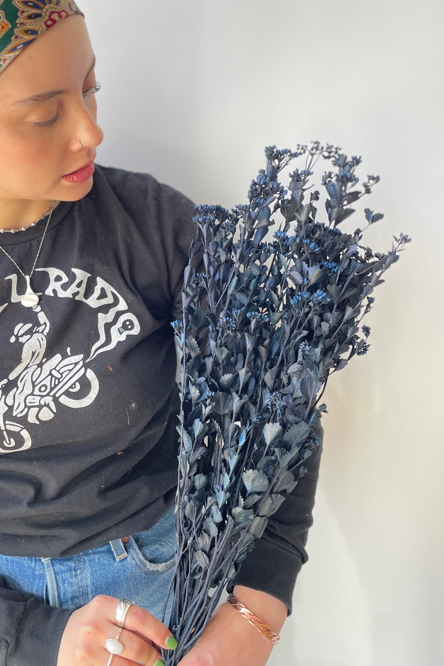 Blue preserved Chuvisco bunch at SPROUT HOME being held by a staff member. ©Sprout Home