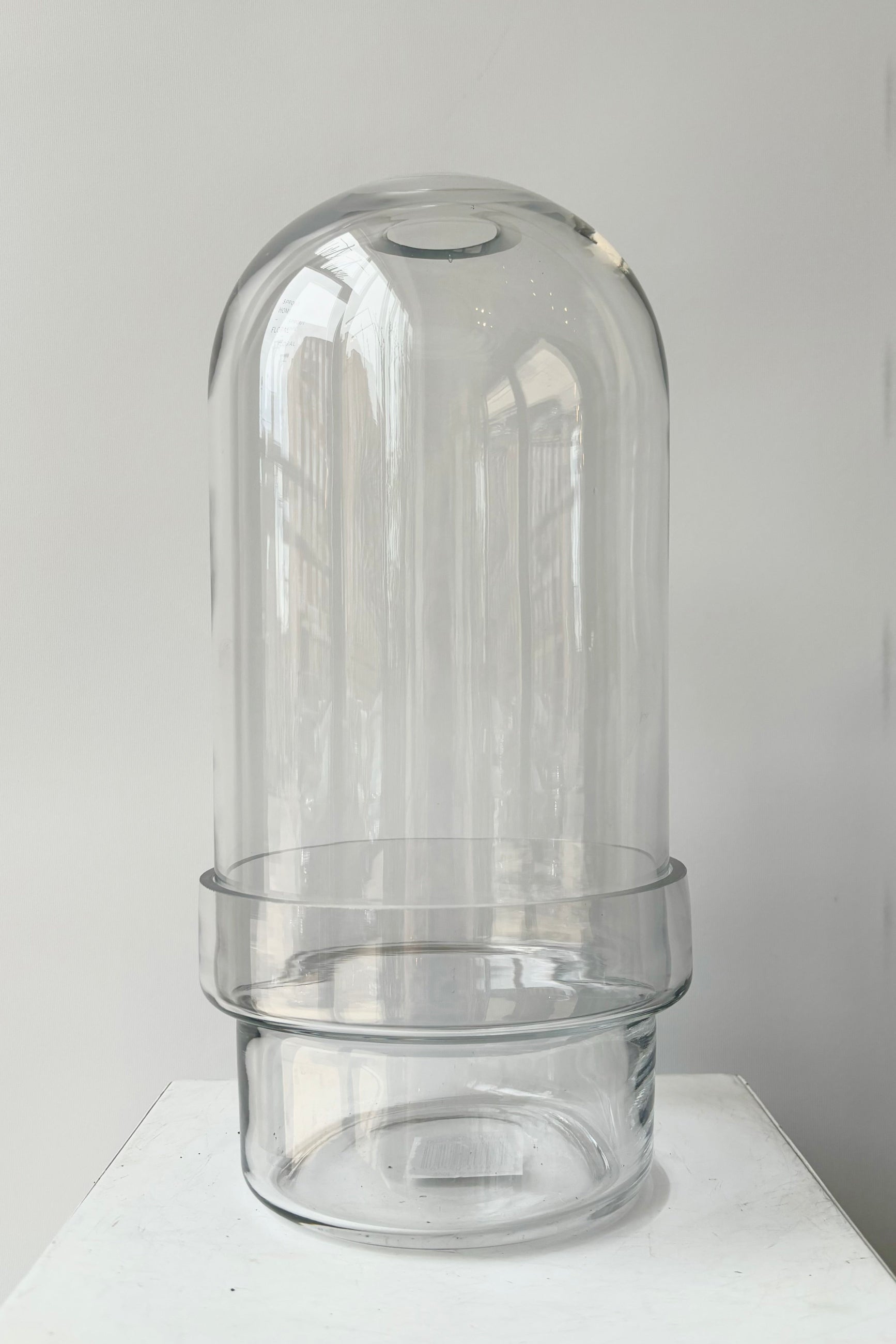 Two piece clear glass, capsule style terrarium unplanted against white background ©Sprout Home