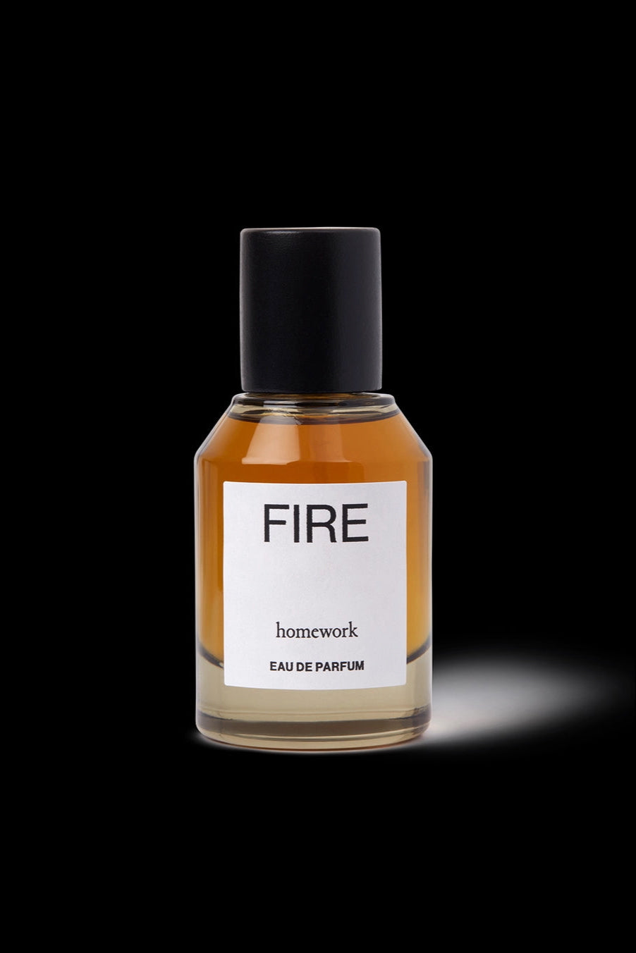Fire Eau de Parfum Perfume bottle labeled 'FIRE' by 'homework' on a black background ©Homework