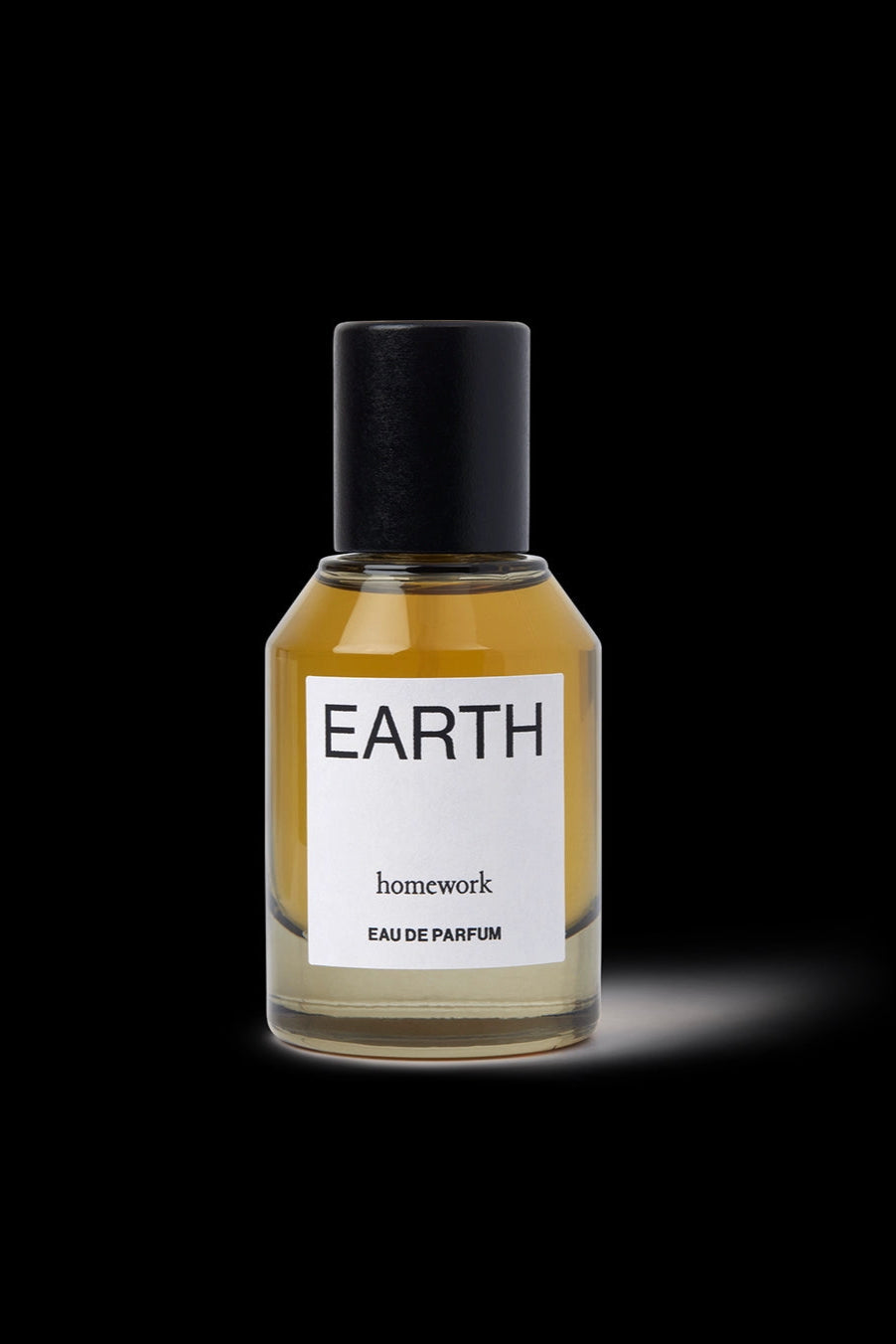 Earth Eau de Parfum Perfume bottle labeled 'Earth' by 'homework' on a black background ©Homework