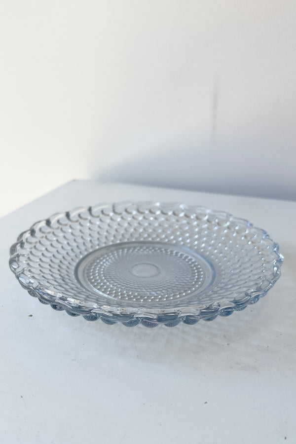 Dentelle Blue Petit point glass plate shown from the side top.