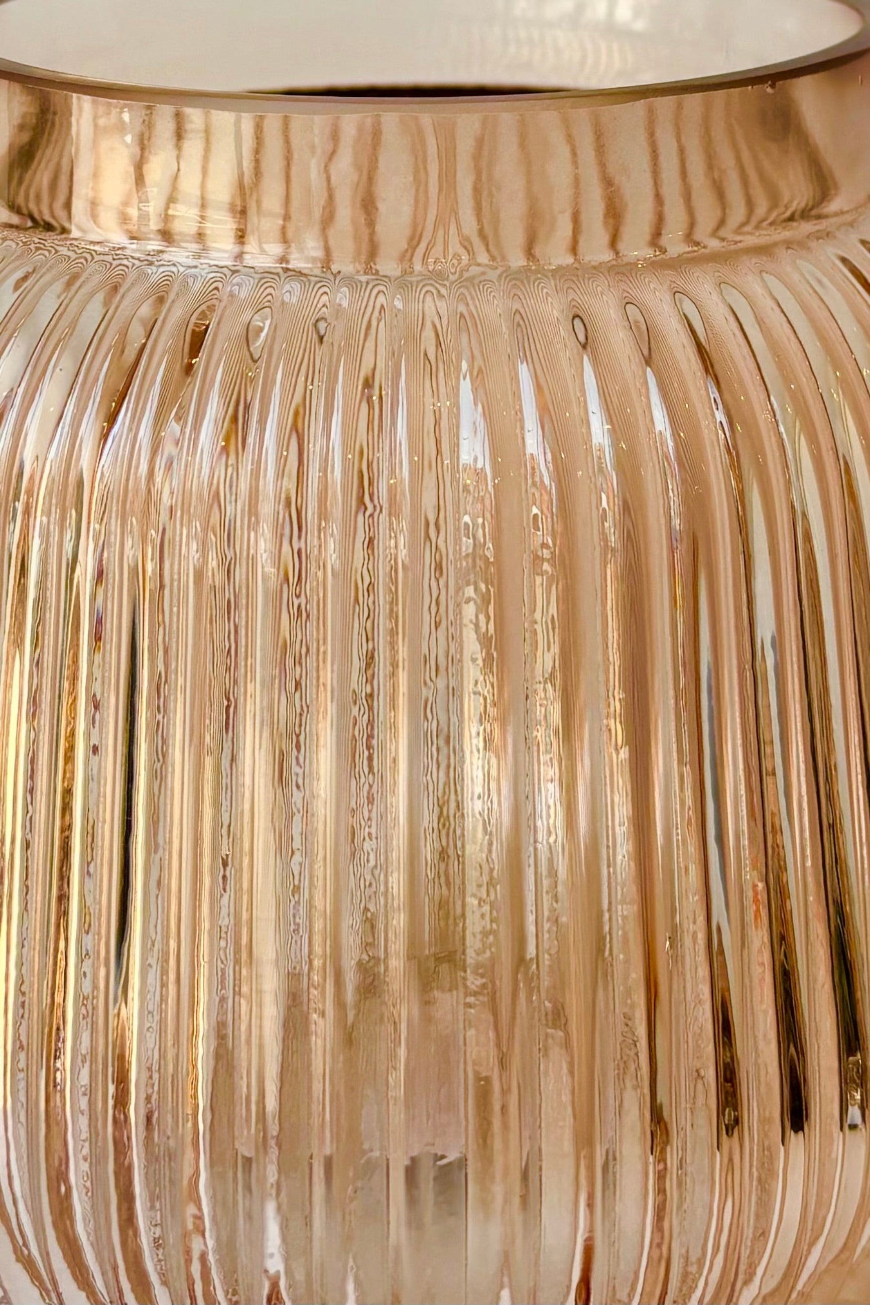 Close up of rose tinted glass vase with vertical ribbing ©Sprout Home