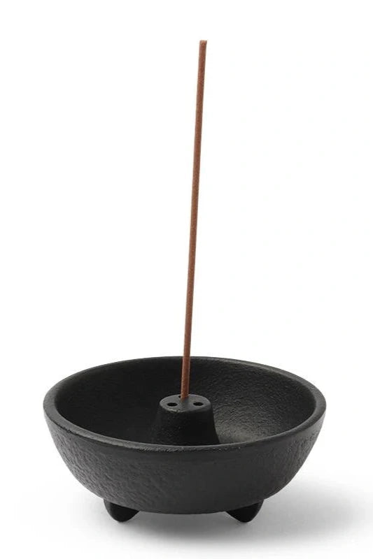 Black weight incense burner holder with an incense stick in it. ©Miiya Company