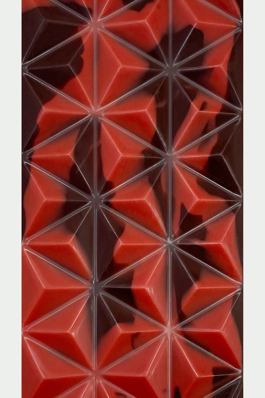 Red geometric pattern of the Dark chocolate bar with strawberries on a white background ©Deux Cranes