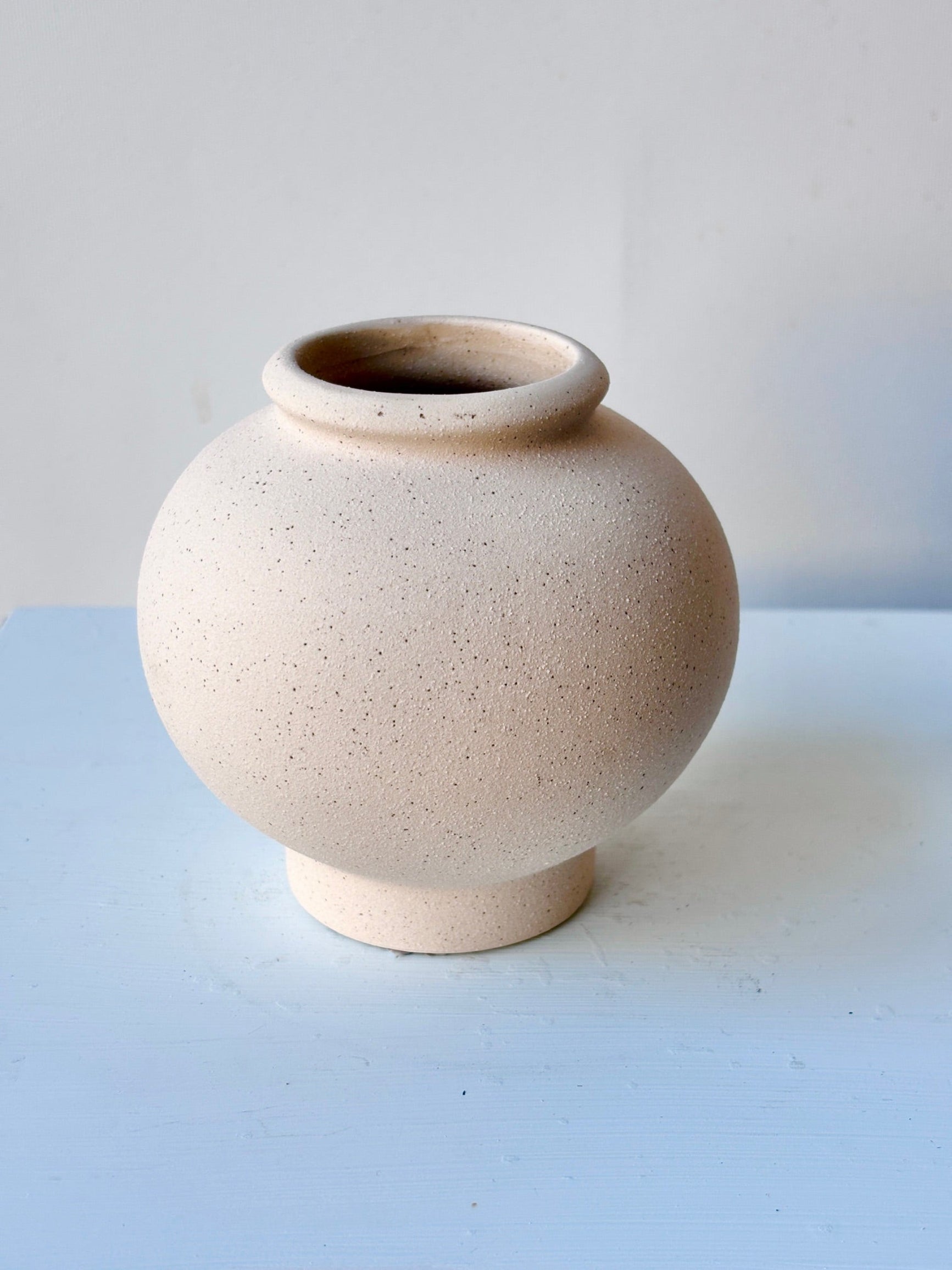Top view of small beige Stockton ceramic vase on a marble surface ©Sprout Home