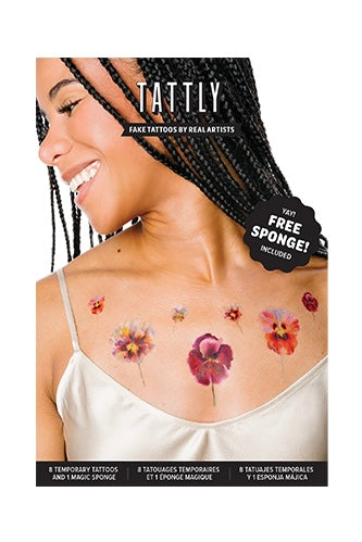 A package of Tattly Wild Pansies Tatoo Set showing a woman wearing them, against a white backdrop.