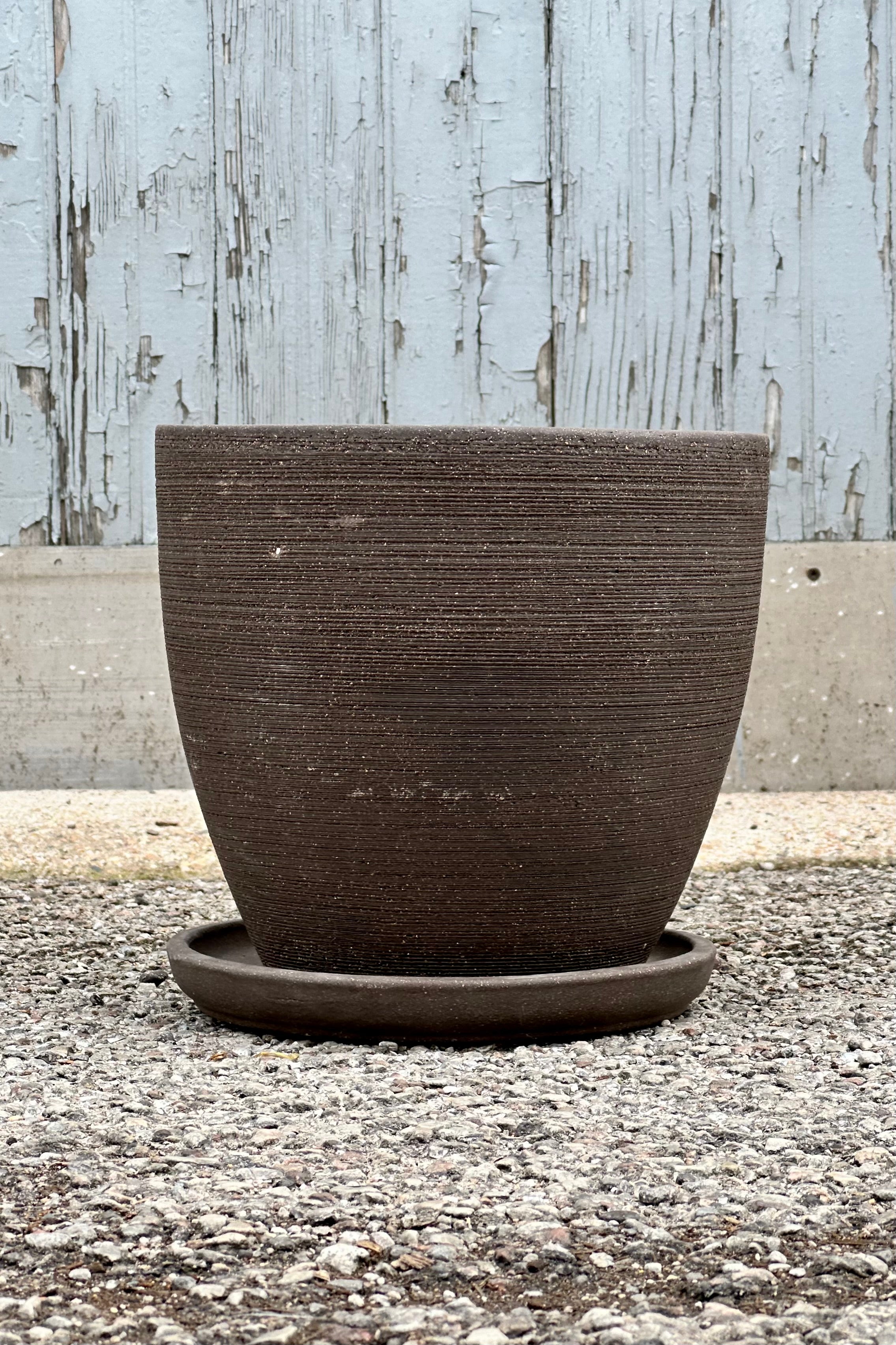Large Lara Carob Planter shown from the side at eye level with its horizontal etching.