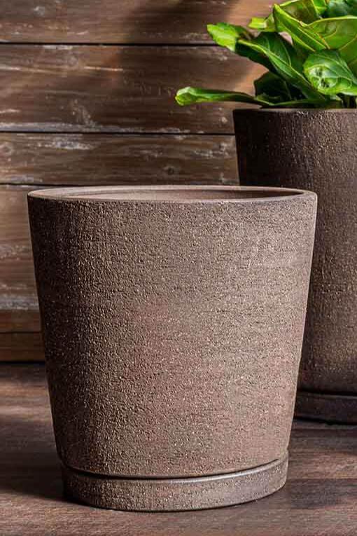 Medium tapered I/O planer in a terra-cotta Peat finish against a woods slatted wall shown from the sides.