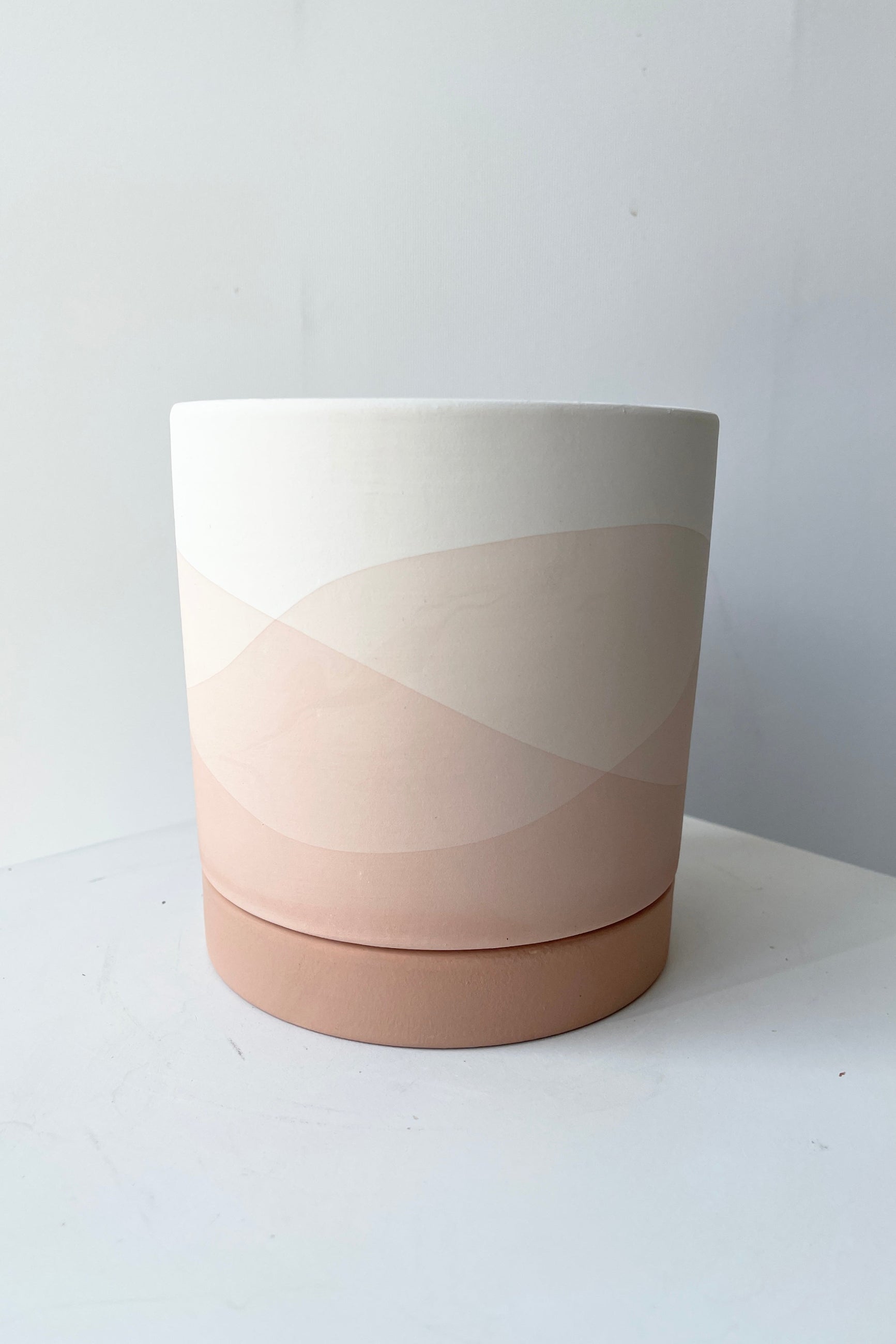 Smal Vesper Pot and saucer shown from eye level its wavy pink and beige design ©Sprout Home