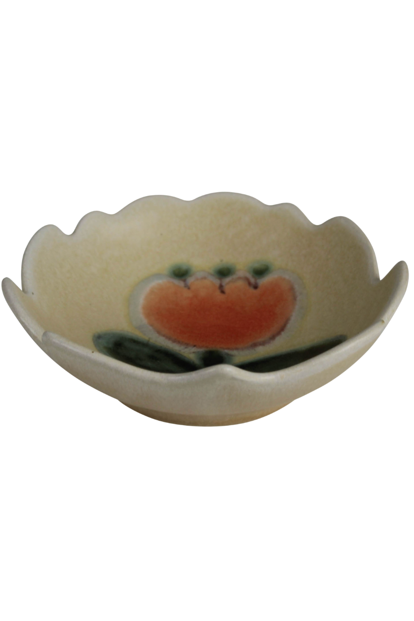 A uneven white bowl with an interior floral motif on a white background ©HomArt