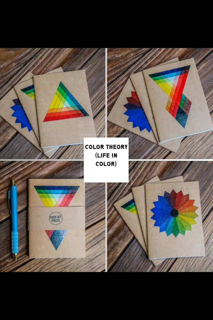 Color Theory Pack Travel Journal 3 Pack Notebooks with geometric designs on a wooden surface. ©Glum Lot Press