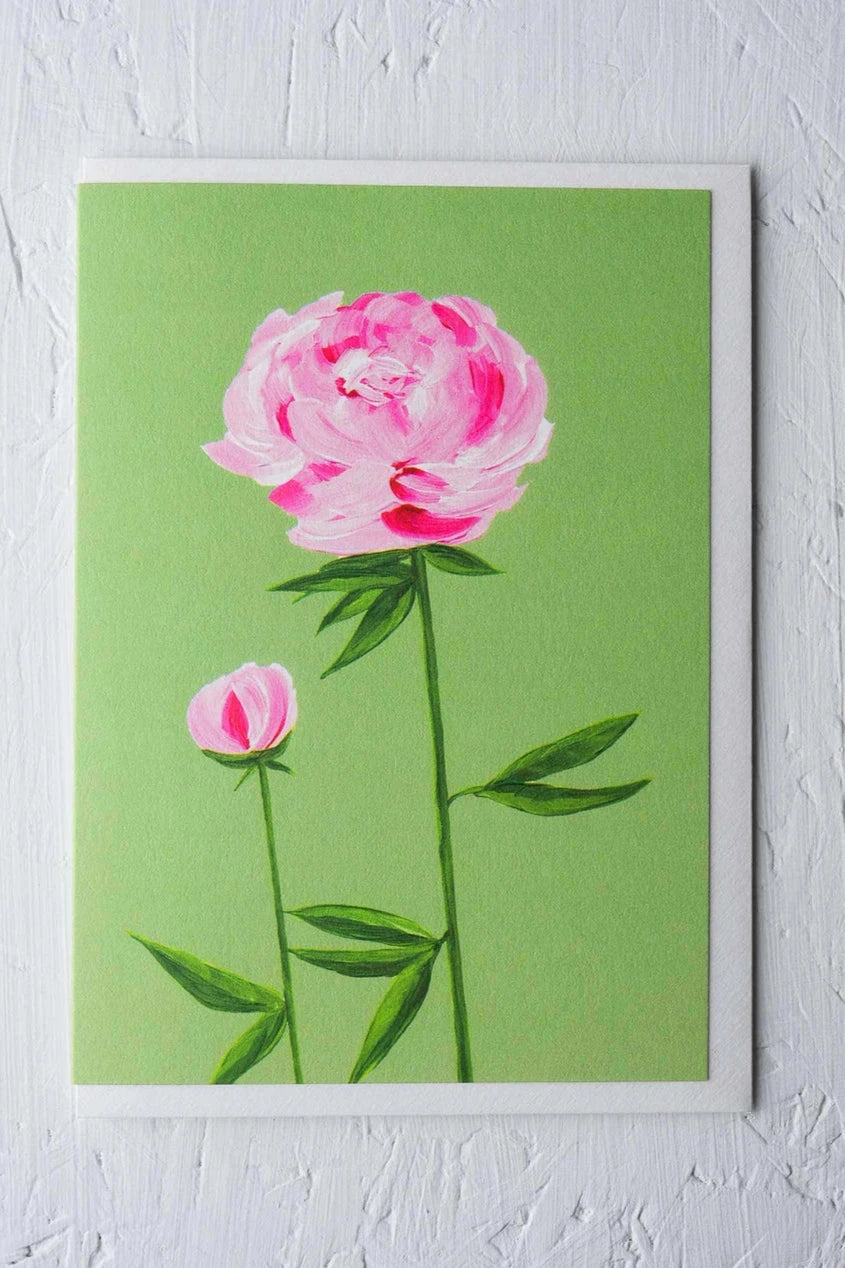 Peony greeting card by Stengun Drawings on white wall with two pink peonies on a green background.