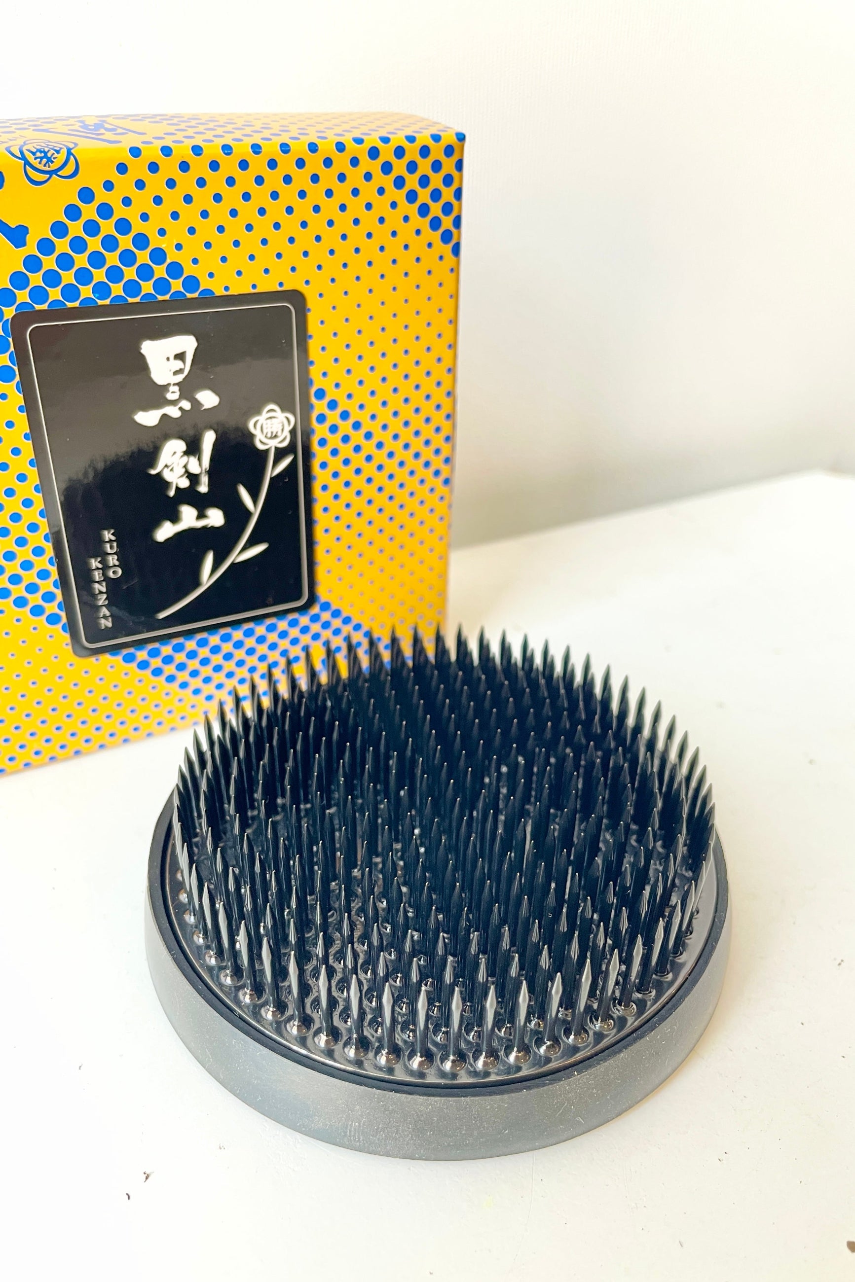 Large Kenzan round black frog out of its packaging sitting on a white table ©Sprout Home