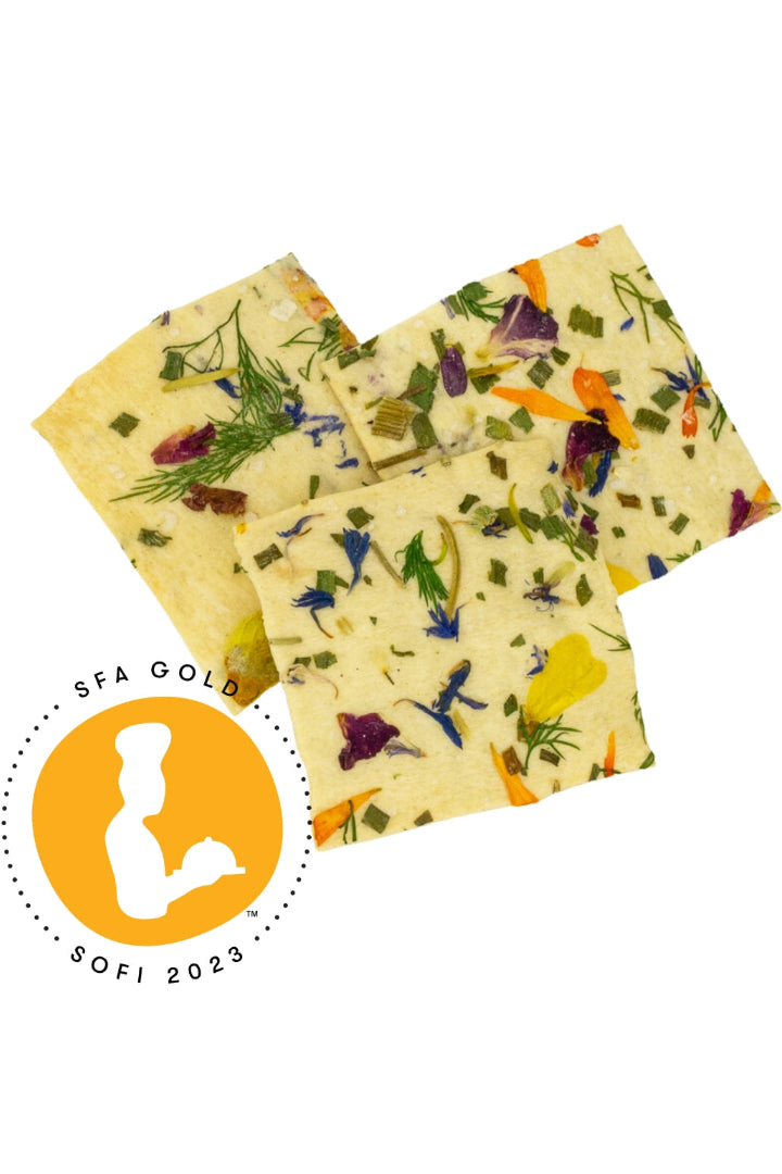 Three square No. 1 Artisanal crackers with floral and herb patterns on a white background, featuring an SFA Gold award logo. ©Flouwer Co