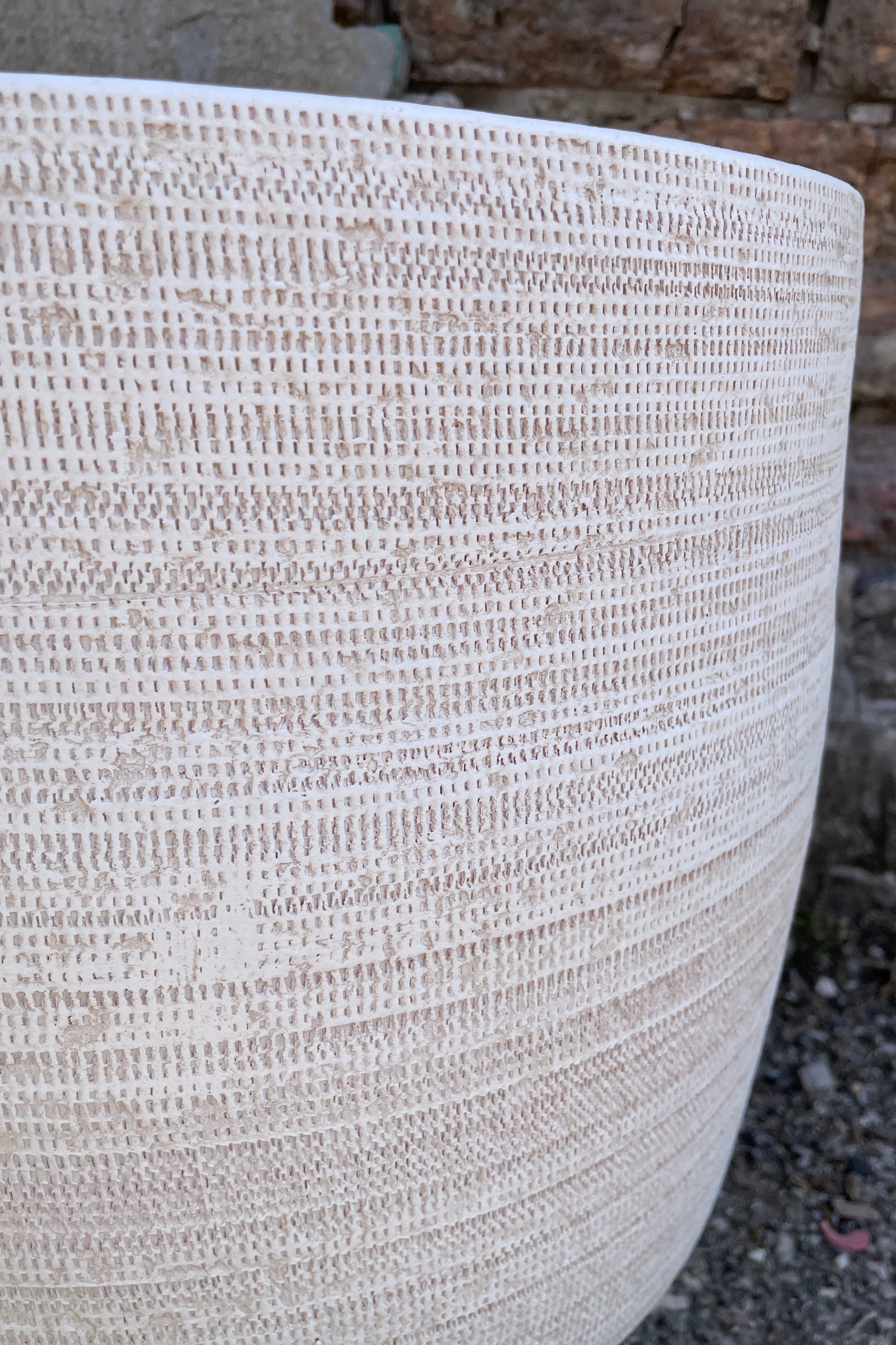 Ray pot in white showing the textured detail on the side of the pot. ©Sprout Home