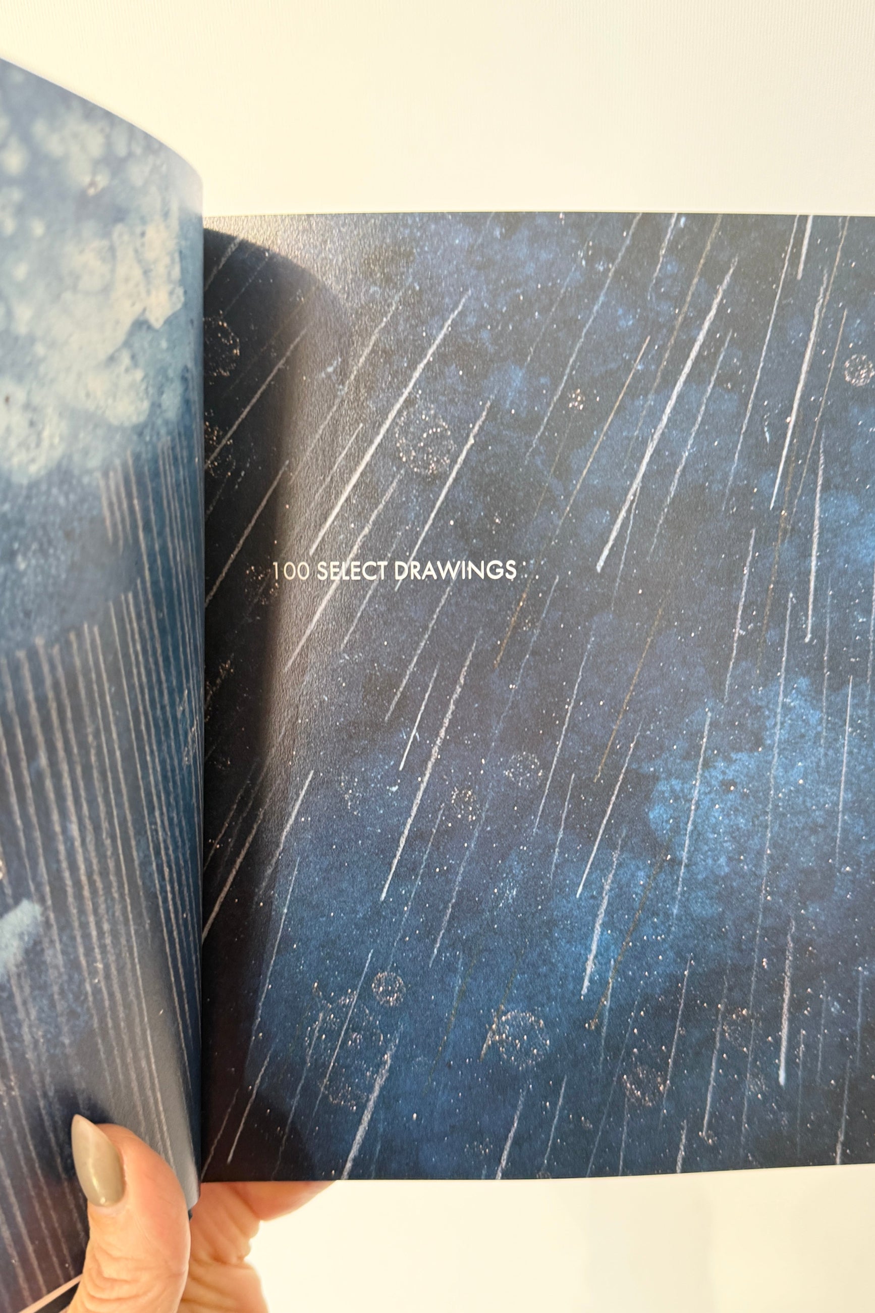 Water of Sky Book open to a page with starry night sky illustration ©Sprout Home