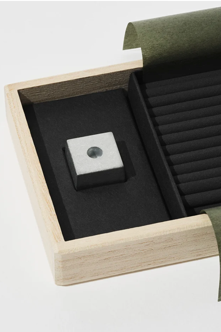 A close view of a box of incense with green paper against a white background ©Nippon Kodo