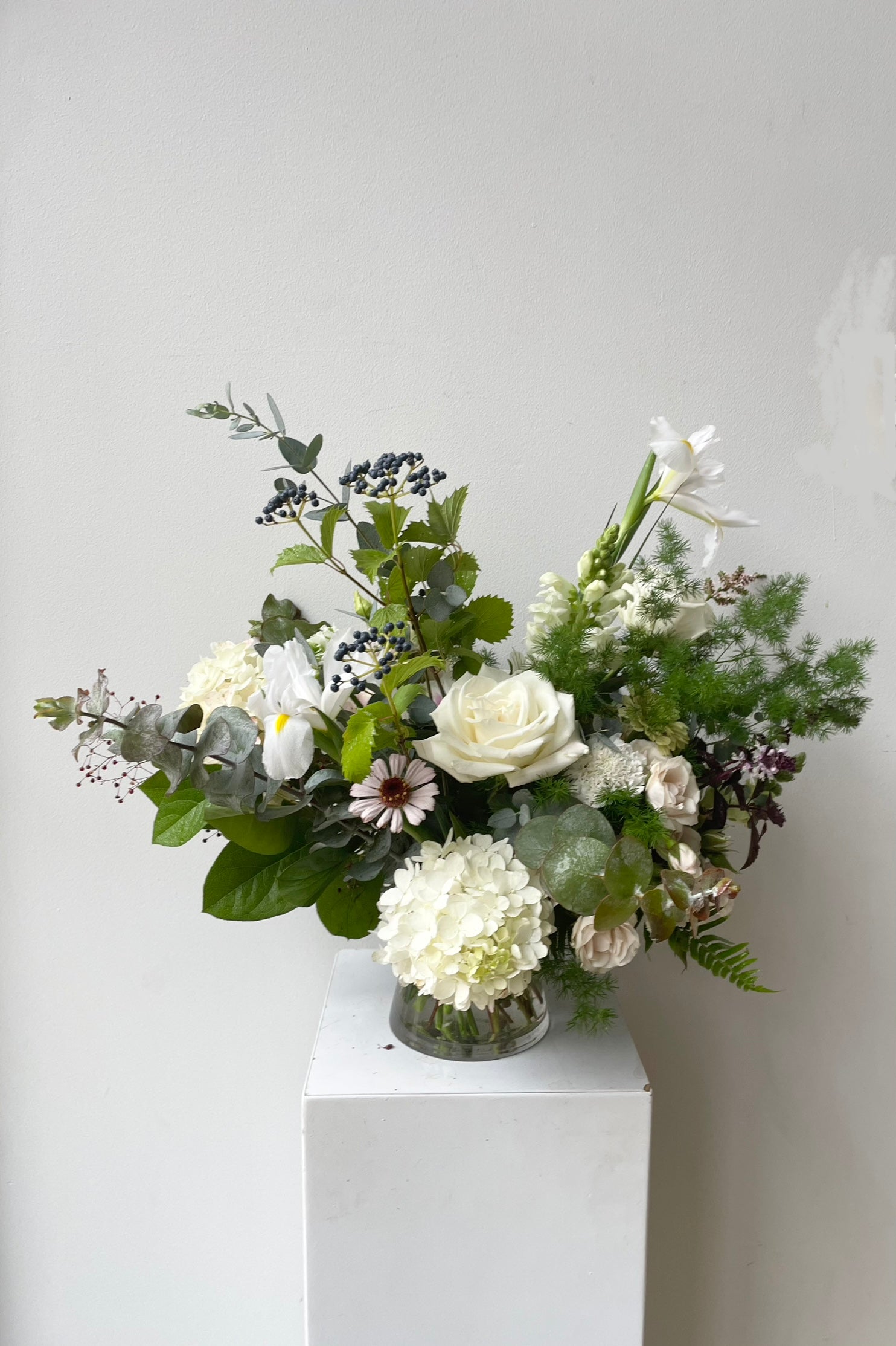 A custom arrangement by Spout Home in shades of white with hydrangea, iris and roses ©Sprout Home #size_$130