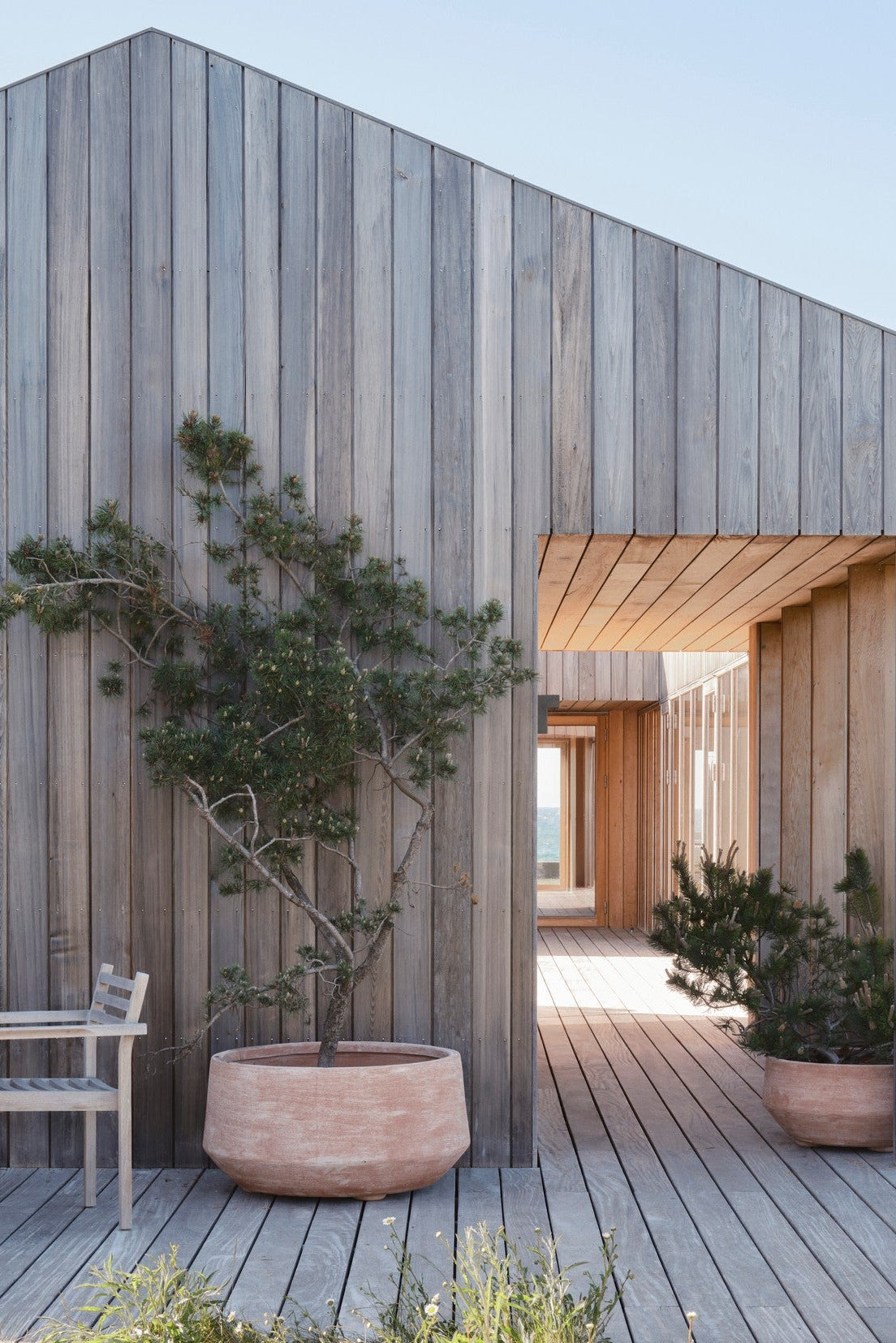 Wooden outdoor structure with a patio area and potted plants in Doma Rosa Planters ©Bergs Potter