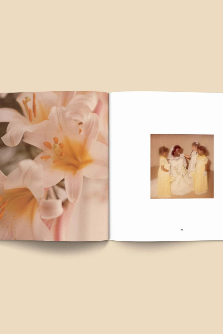Forgotten Flowers Coffee Table Book by Broccoli open to a page with lilies and a vintage wedding photo