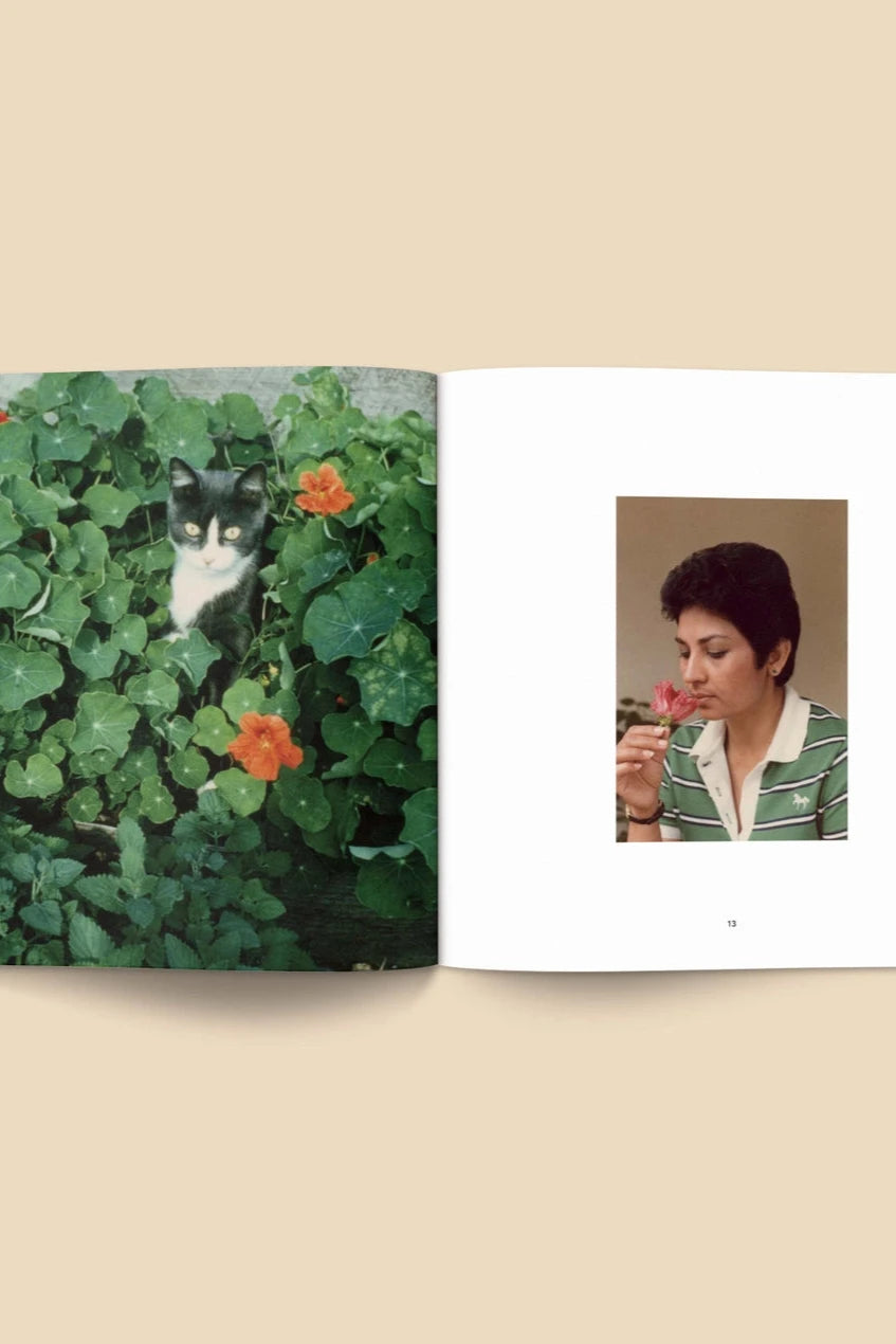Forgotten Flowers Coffee Table Book by Broccoli open to pages with a cat in Nasturtiums and a vintage photo