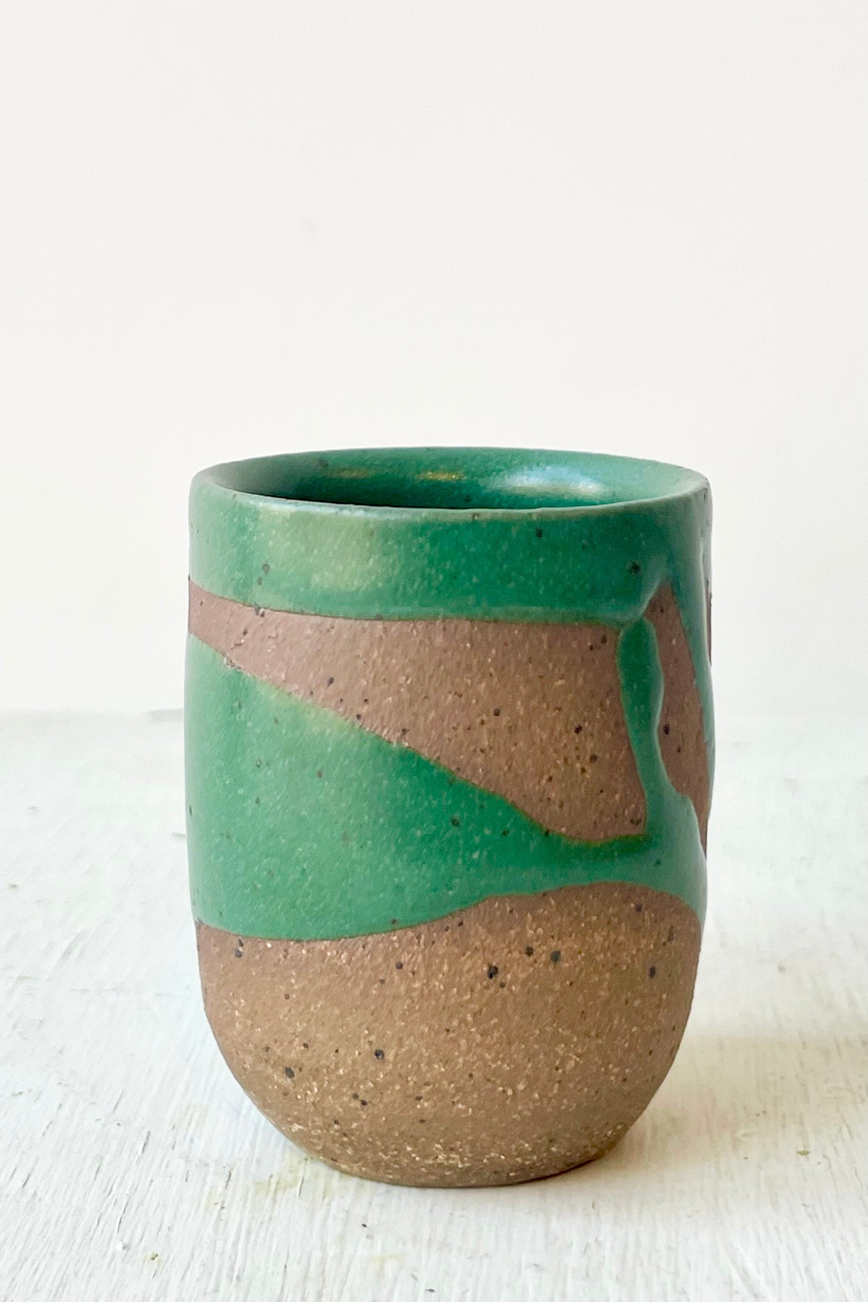 Ceramic cup with green and brown gradient on a white background ©Sprout Home