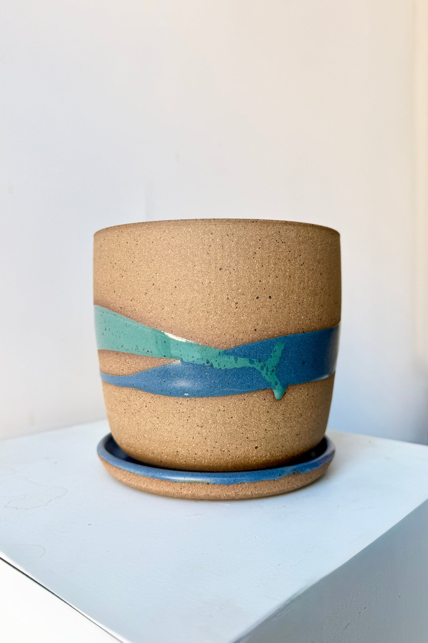 Cylinder Pot & Saucer Denim and Dark Teal Splash Glaze 4.5" handmade by Christina Kosinski on a white surface ©Sprout Home