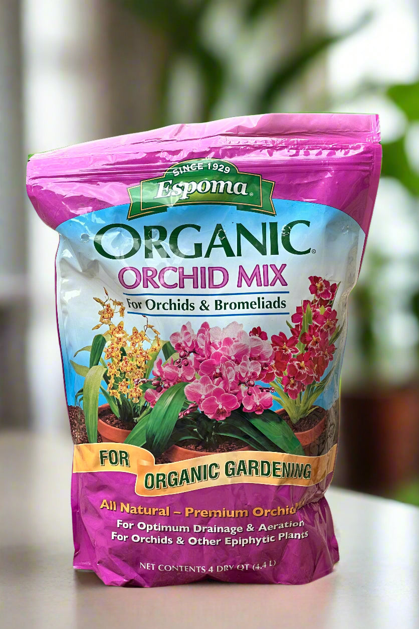 Bag of Espoma Orchid Mix in a room with plants in the background