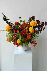 Earth custom arrangement by Sprout Home featuring sunflower and marigolds in August