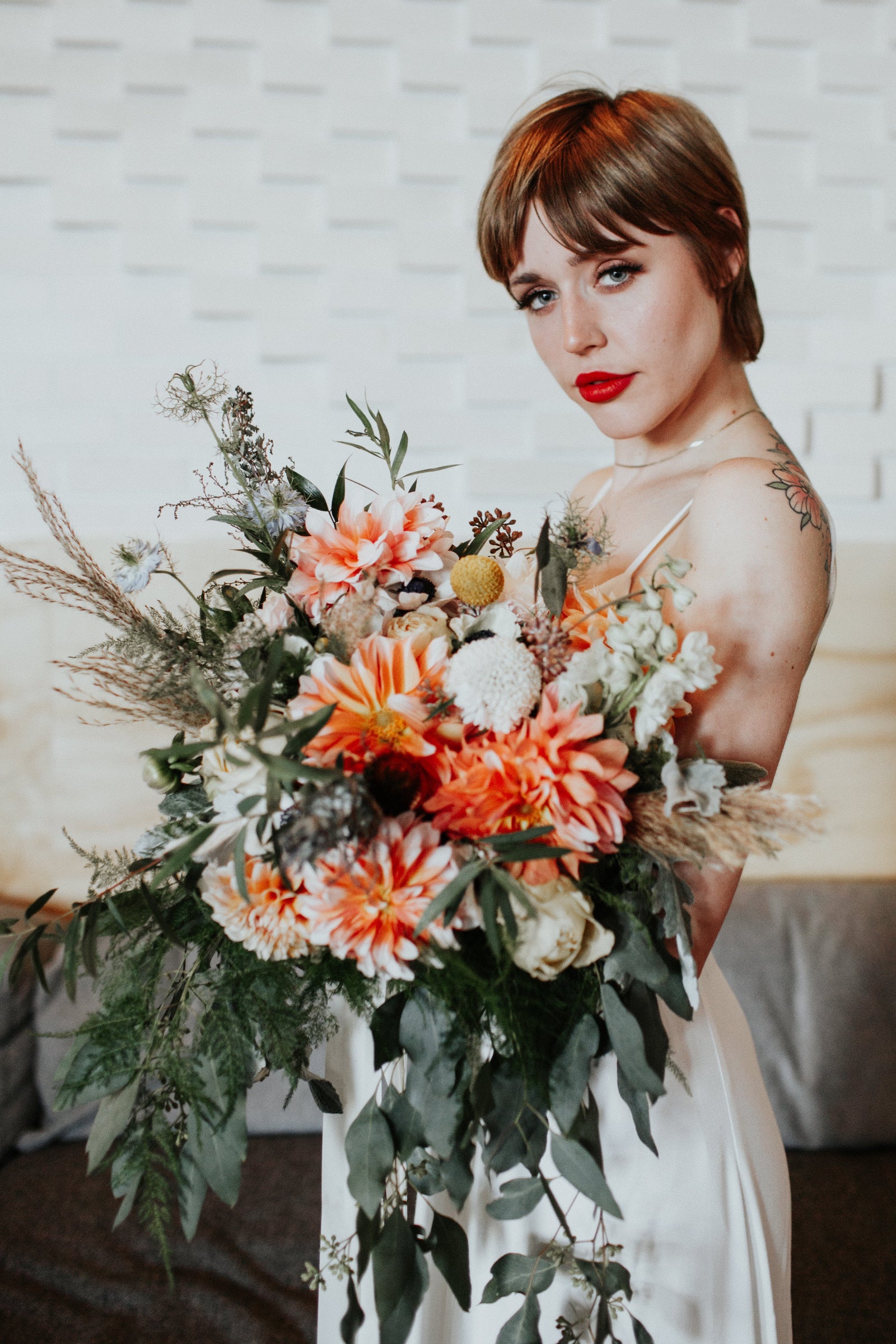 Elyssa Greg wedding floral bouquet in orange and cream by Sprout Home. photograph by Loren Weddings