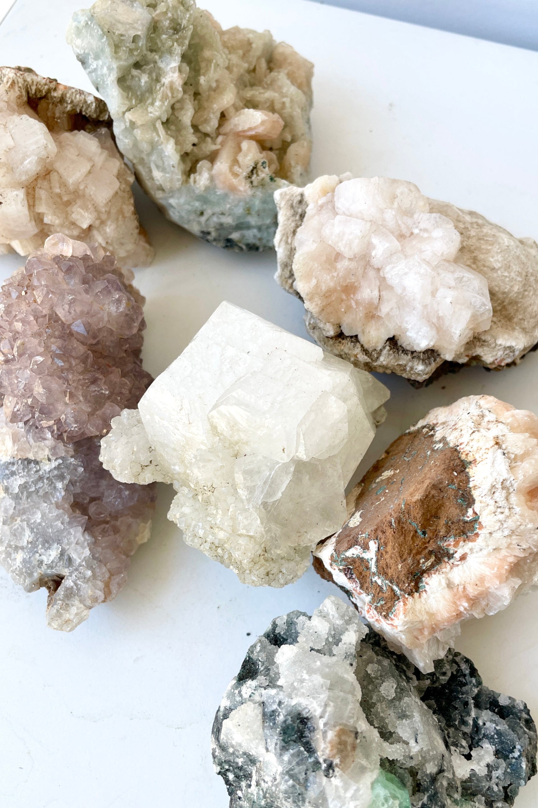 Various Zeolite Specimens on a white surface at Sprout Home. ©Sprout Home