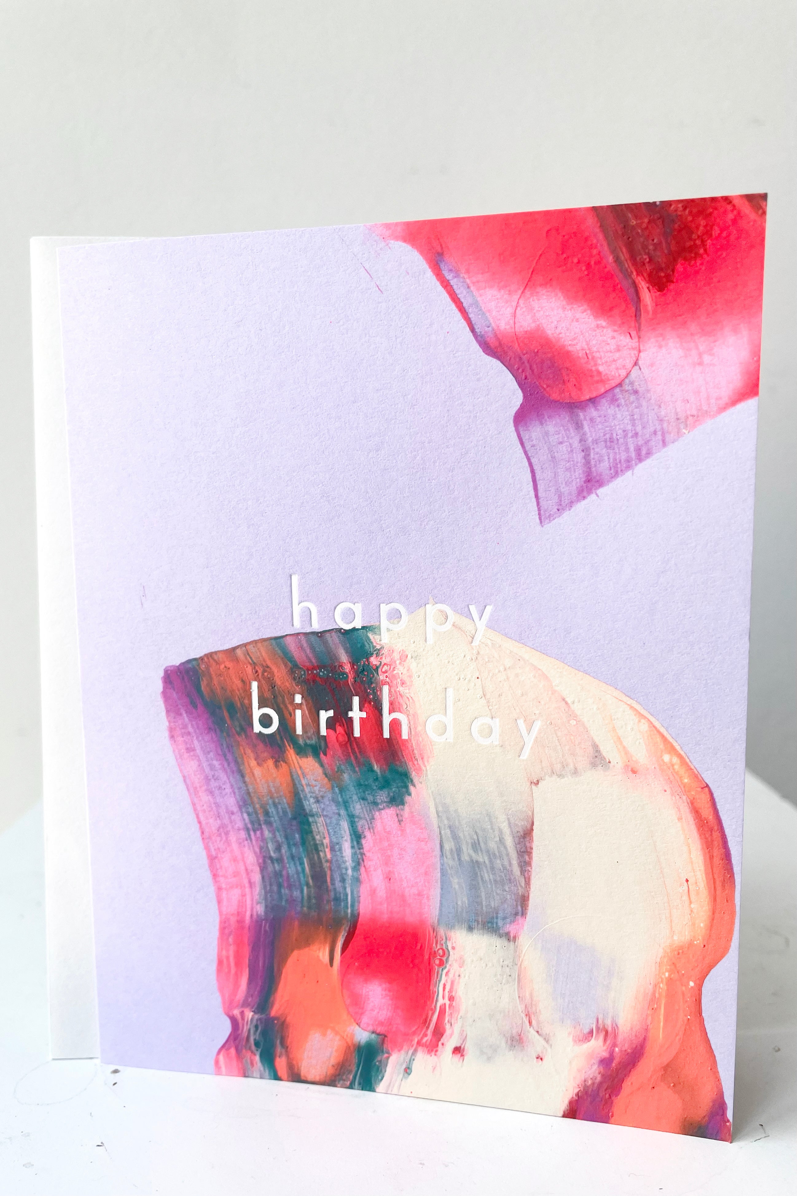 A full frontal view of Orchid Birthday Card and envelope against white backdrop