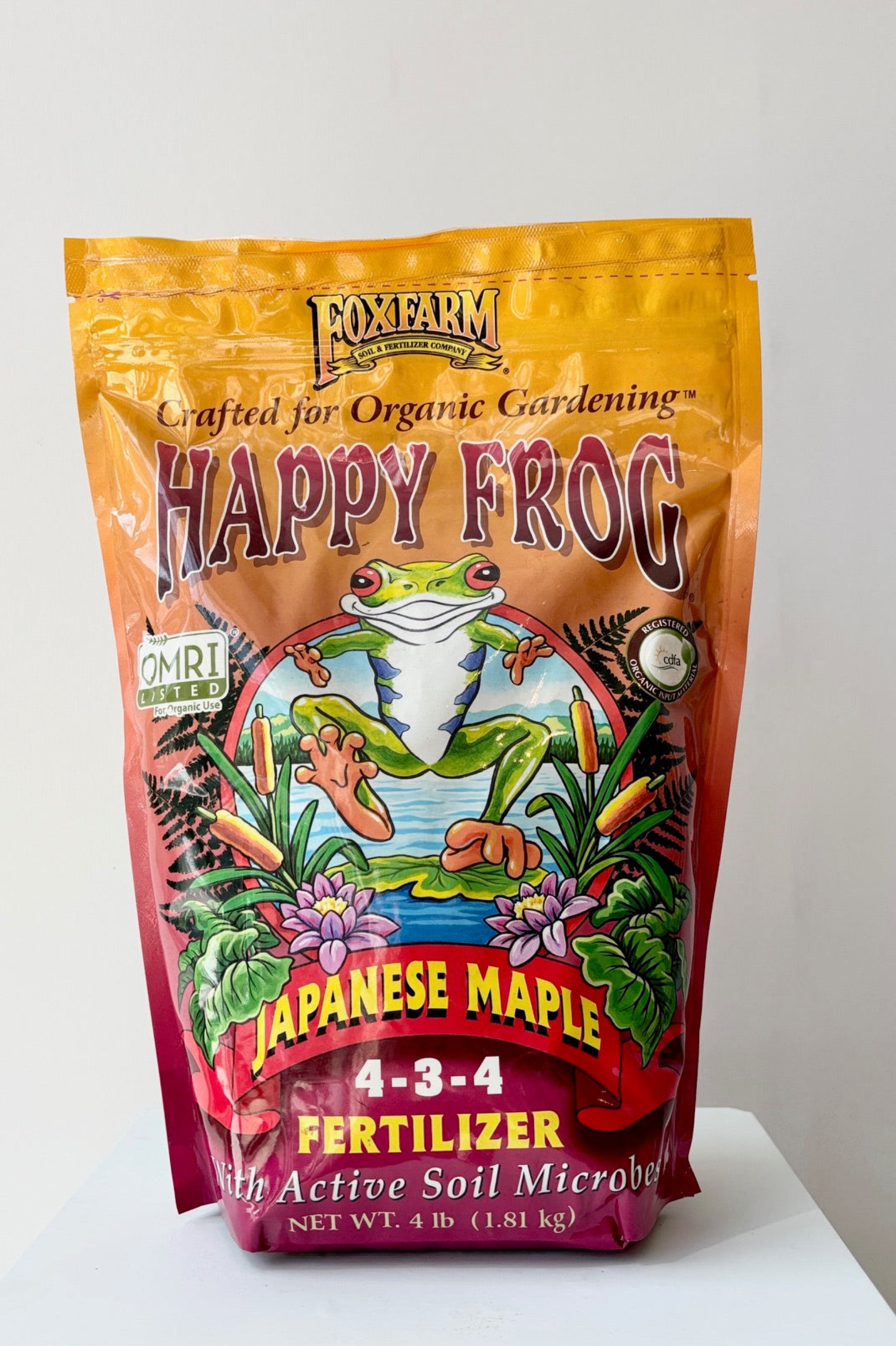 Happy Frog Japanese Maple fertilizer with active soil microbes in a 4 pound bag displayed against a white wall ©Sprout Home