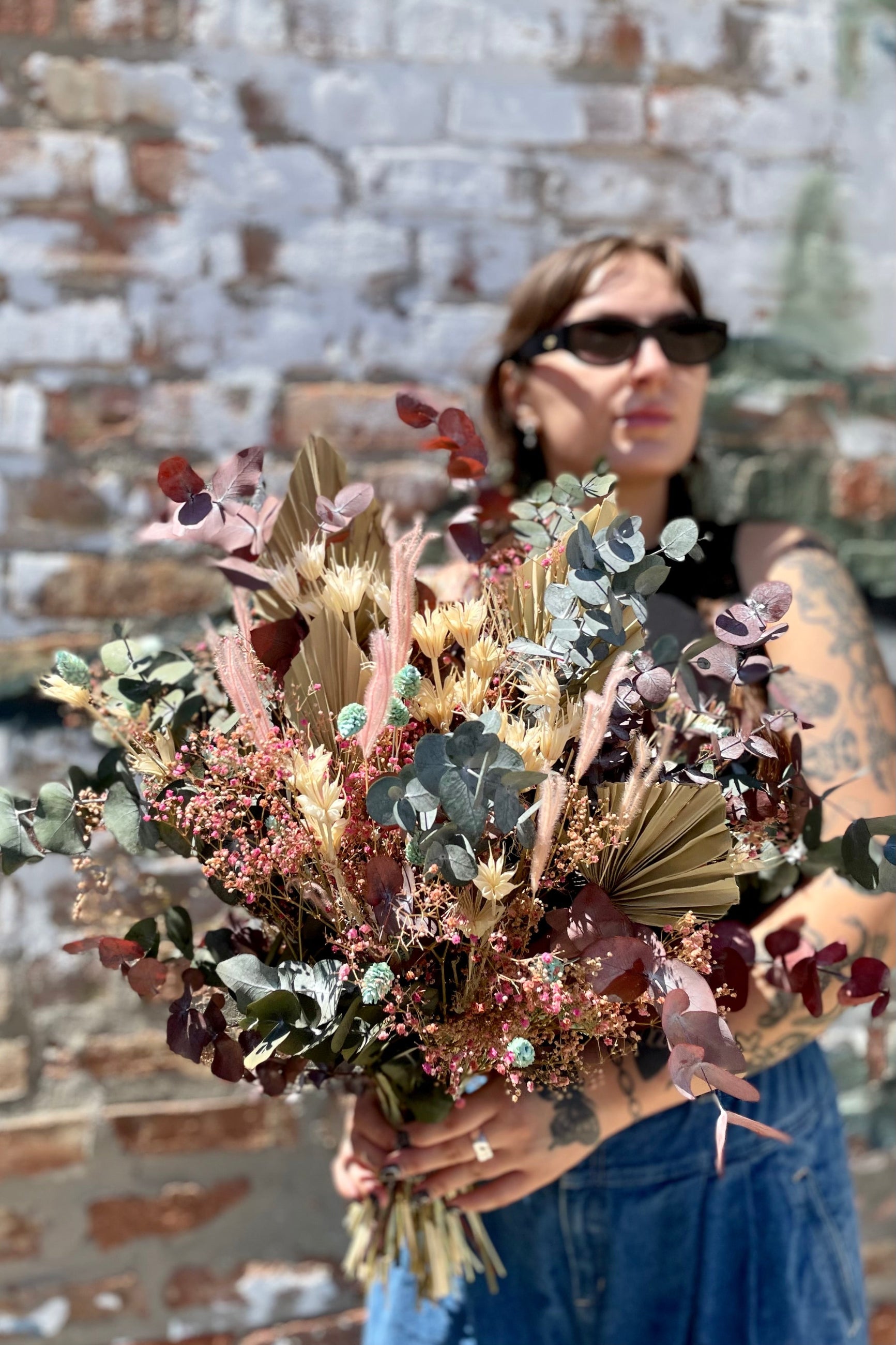 Faerie Preserved Sprout Home arrangement being held in hand. Shades of mint, pink, burgundy and off-white. ©Sprout Home #size_PLP