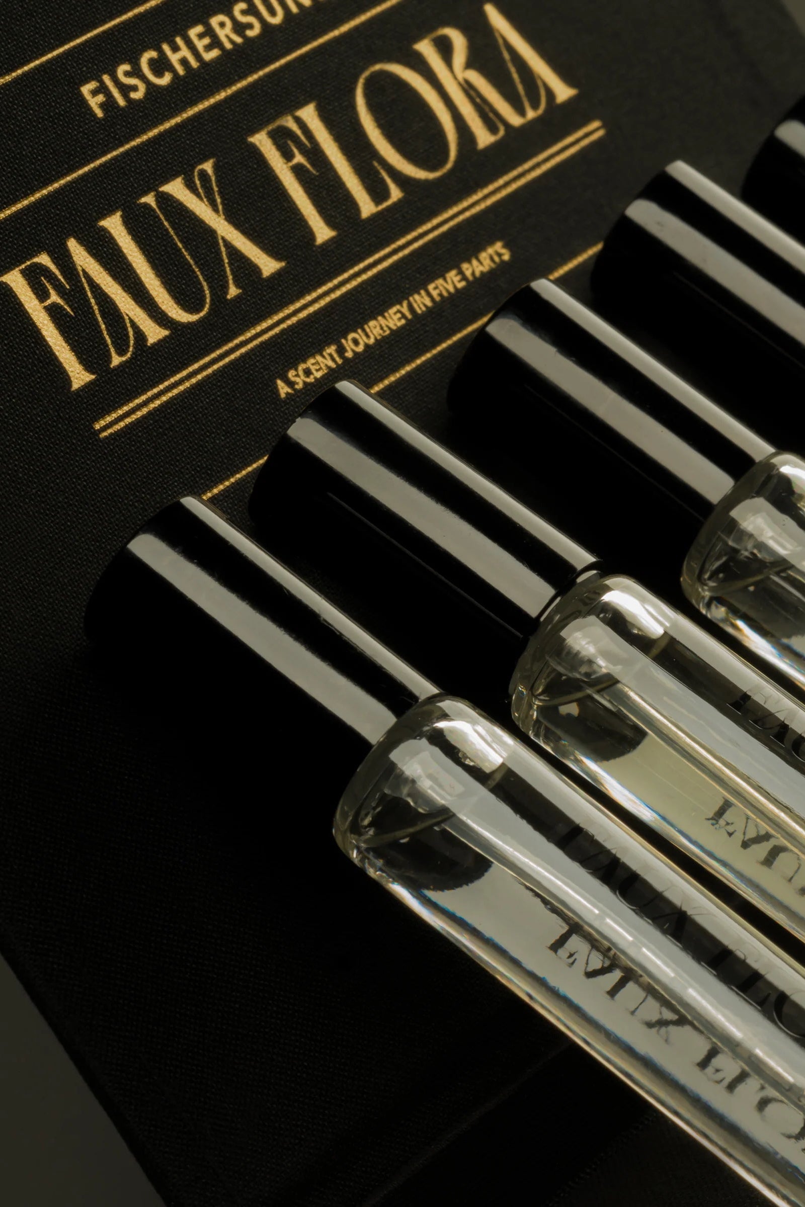 Set of Fischersund Faux Flora perfume bottles with a black box in the background. ©Fischersund