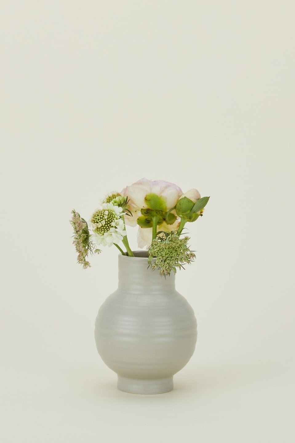 Gray Essential Vase with some stems in it by Hawkins New York.