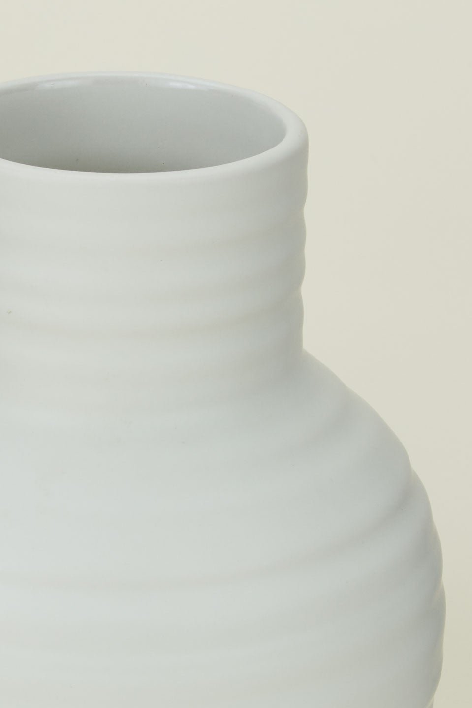 Bone colored Essential vase by Hawkins New York showing the ribbed finish up close.
