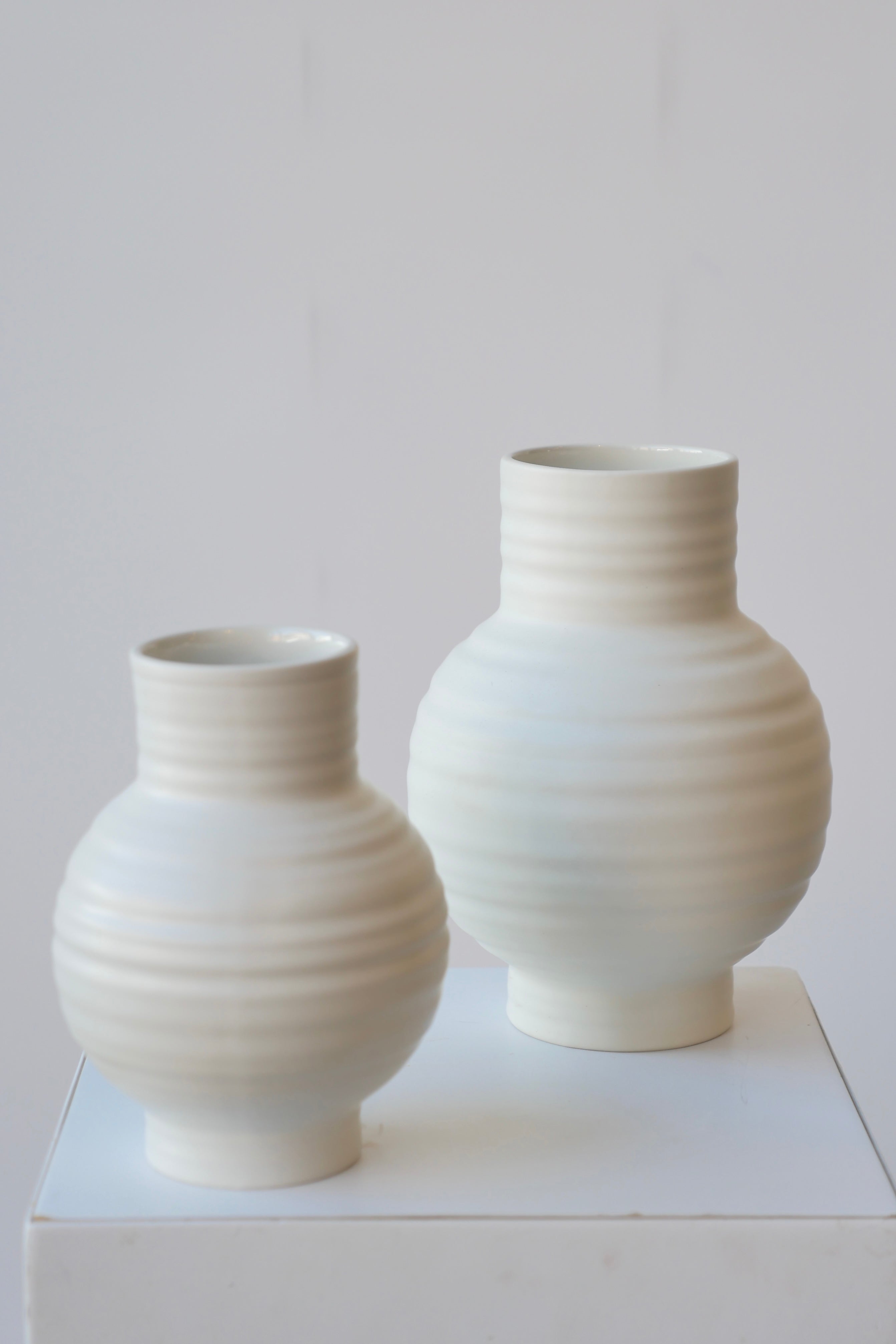 Essential Bone ceramic vase pair, small and large showing the horizontal ridges.