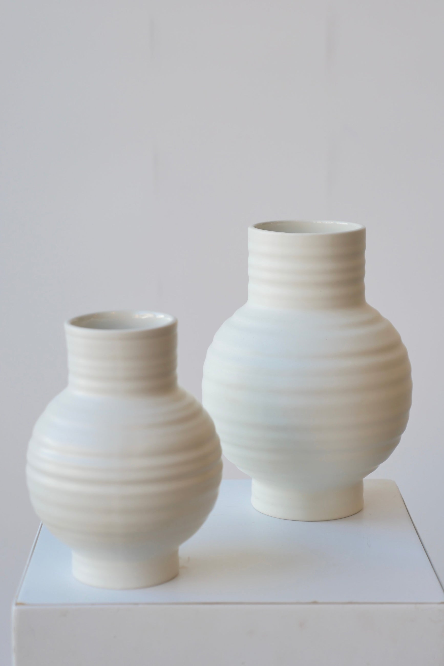 Essential Bone ceramic vase pair, small and large showing the horizontal ridges. ©Sprout Home