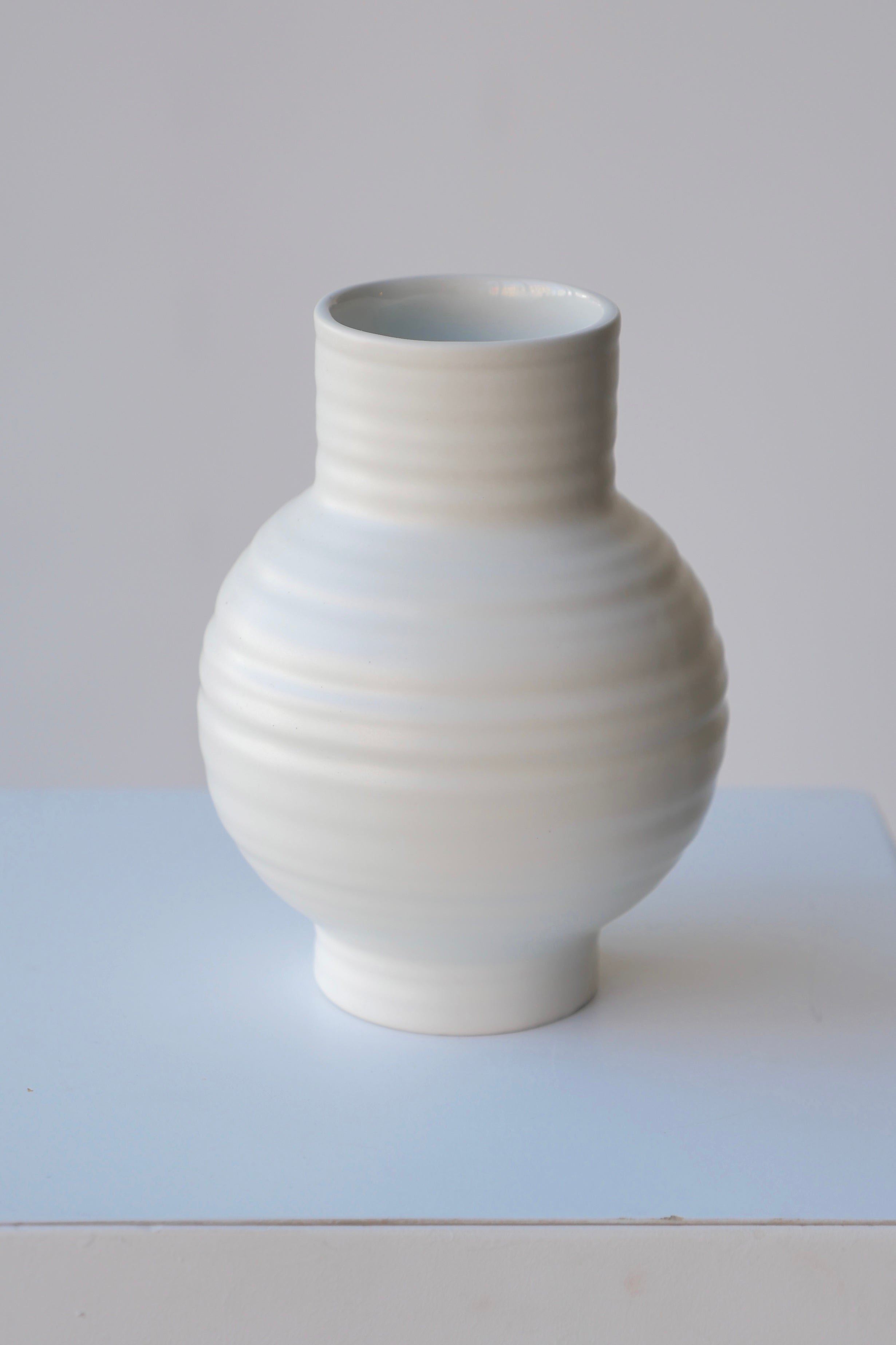 Essential Bone vase in Small by Hawkins looking from the side top against white.