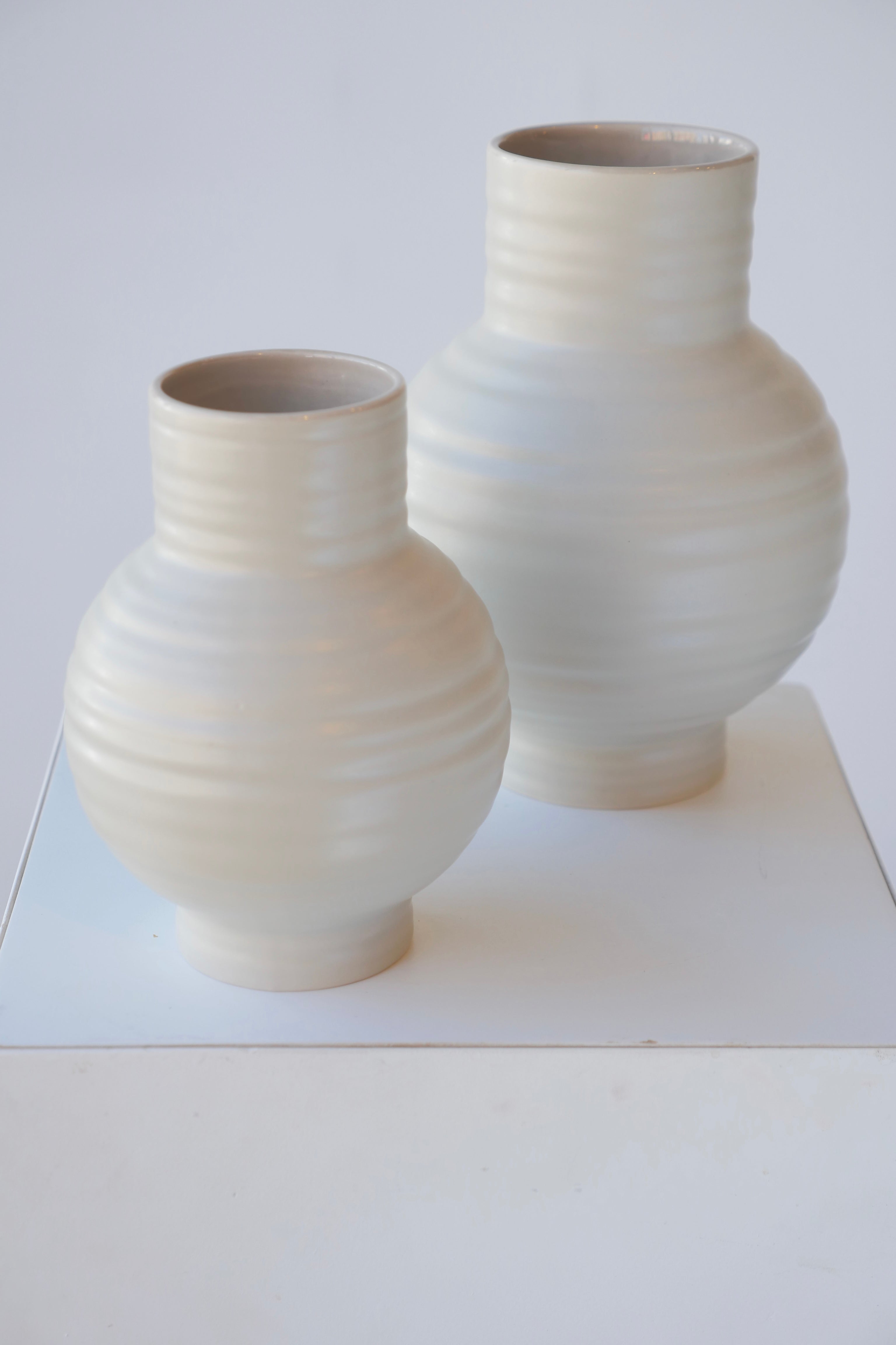 Essential light grey Essential vases by Hawkins NY viewed from the top side on white.
