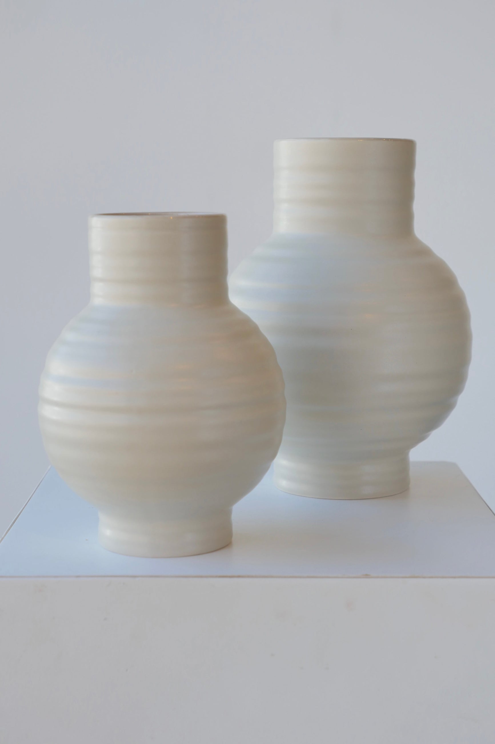 Pair of Essential Hawkins Light grey vases against white. ©Sprout Home