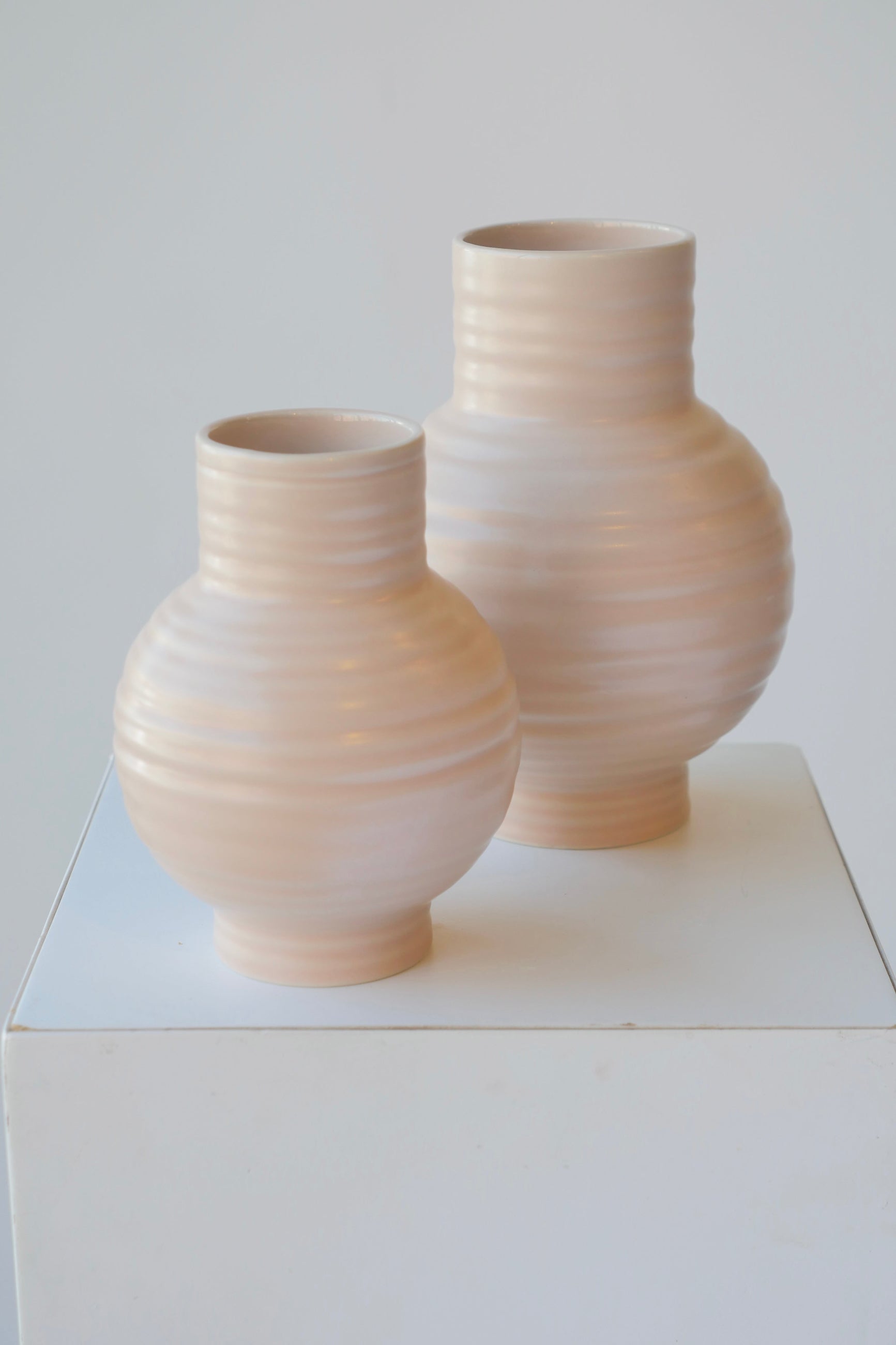 A par of large and small Essential blush vases on white. ©Sprout Home