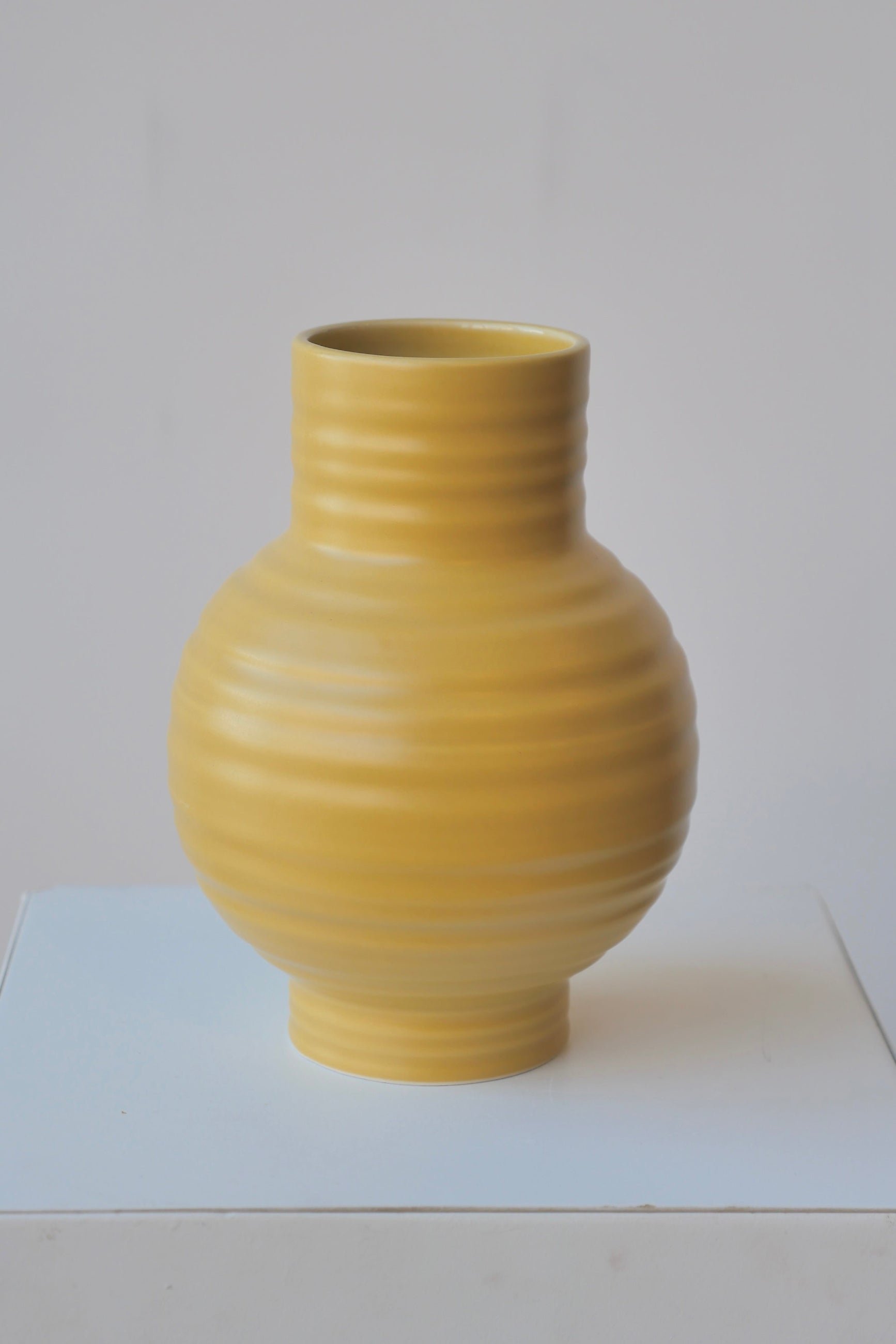 The large Essential Mustart Ceramic vase by Hawkins showing the horizontal ridges. ©Sprout Home