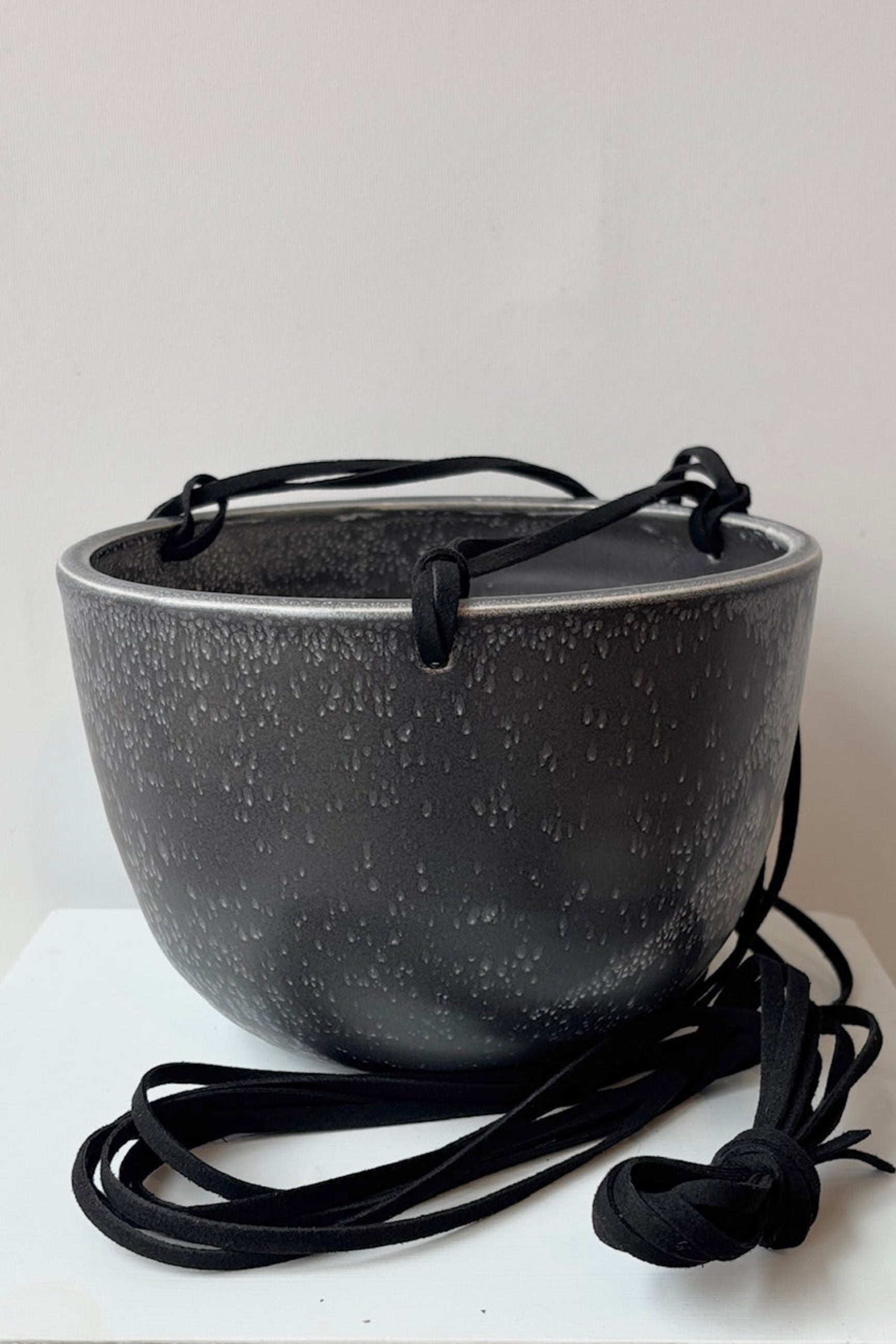 Black speckled pot with black cord on a white background ©Sprout Home